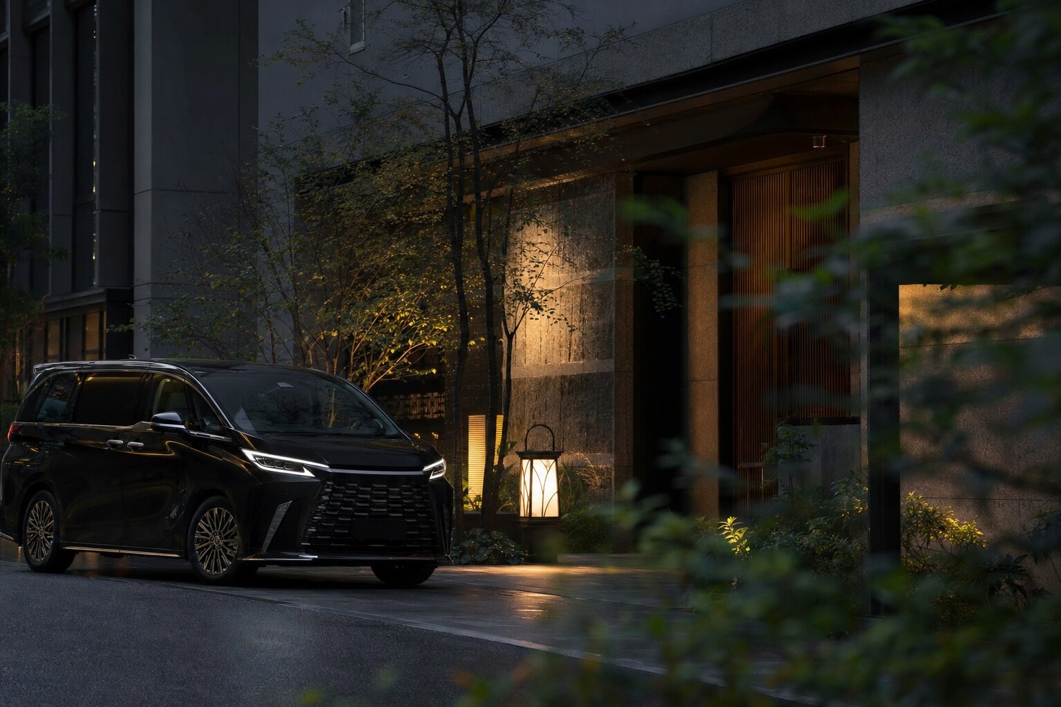 A black Lexus LM 500 providing private luxury transfer services at an Osaka hotel.