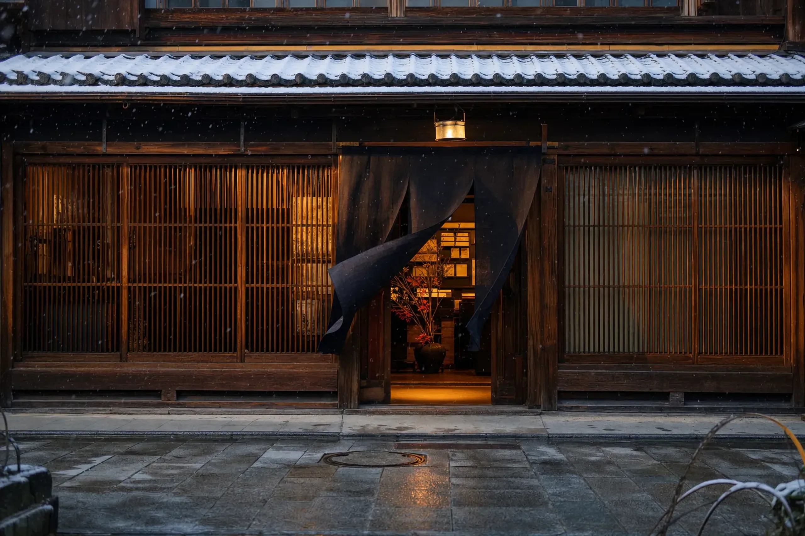 The traditional storefront of the Shoyeido incense house in Kyoto with hanging noren curtains and wooden lattice facade