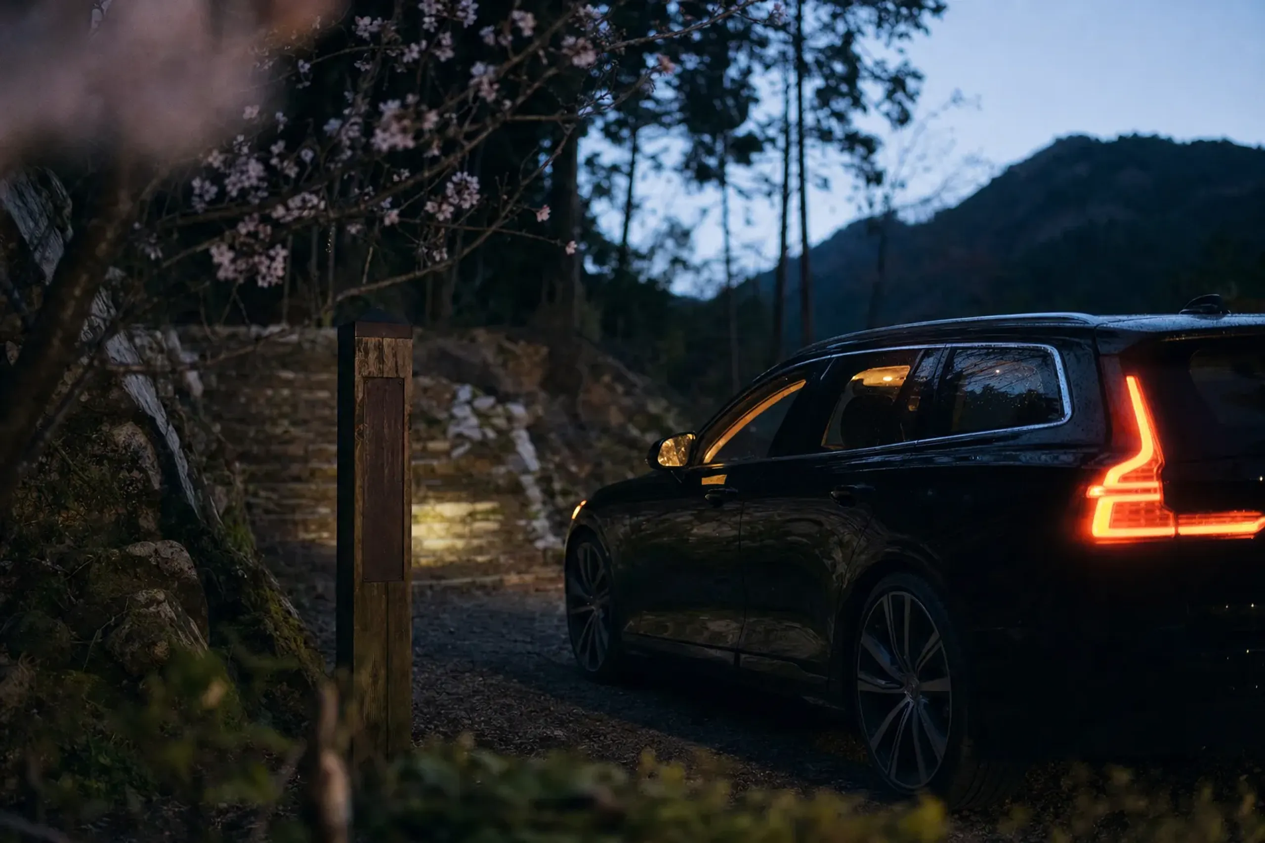 a support vehicle parked at a rural trailhead pickup point along the Nakahechi route at dusk