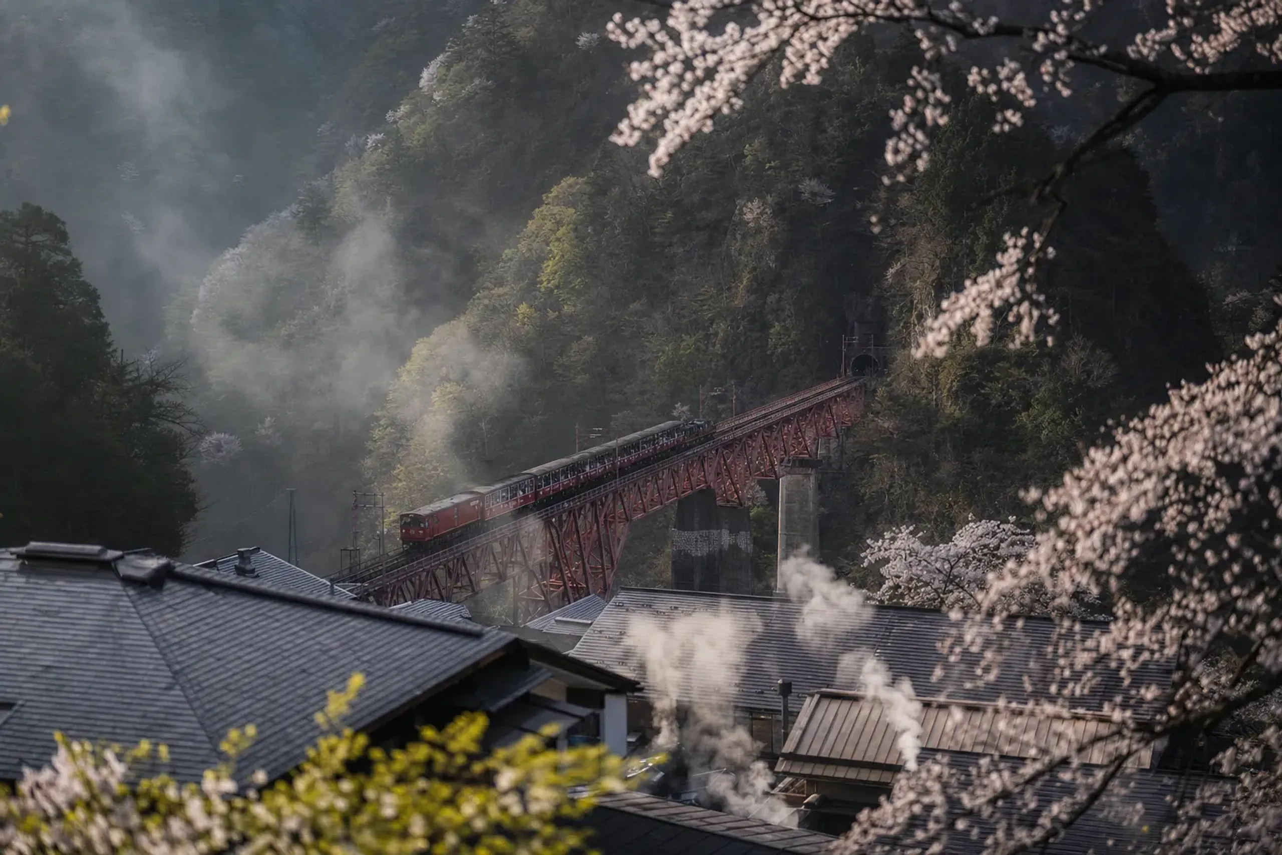 Unazuki Onsen town at the mouth of the Kurobe Gorge, with the open-air narrow-gauge train departing from Unazuki Station