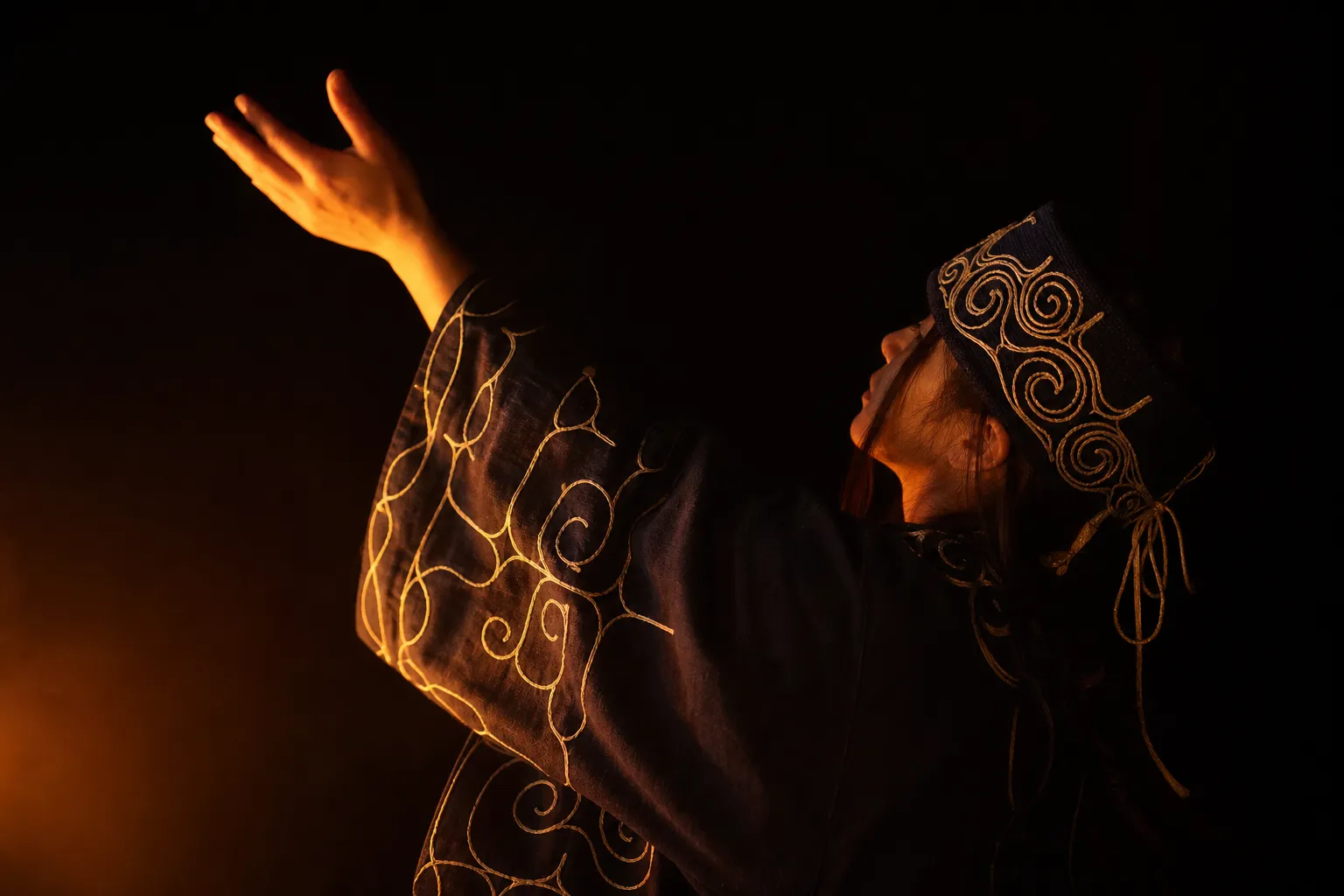 A close-up photograph capturing a traditional Ainu dancer in intricately embroidered robes Moving gracefully before a glowing fire, showcasing the vibrant patterns and spiritual indigenous heritage of Hokkaido.