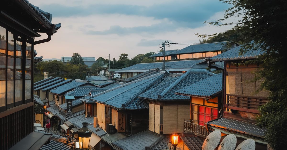 Traditional machiya rooftops in Kyoto showcasing the historic architecture protected by local tourism initiatives.