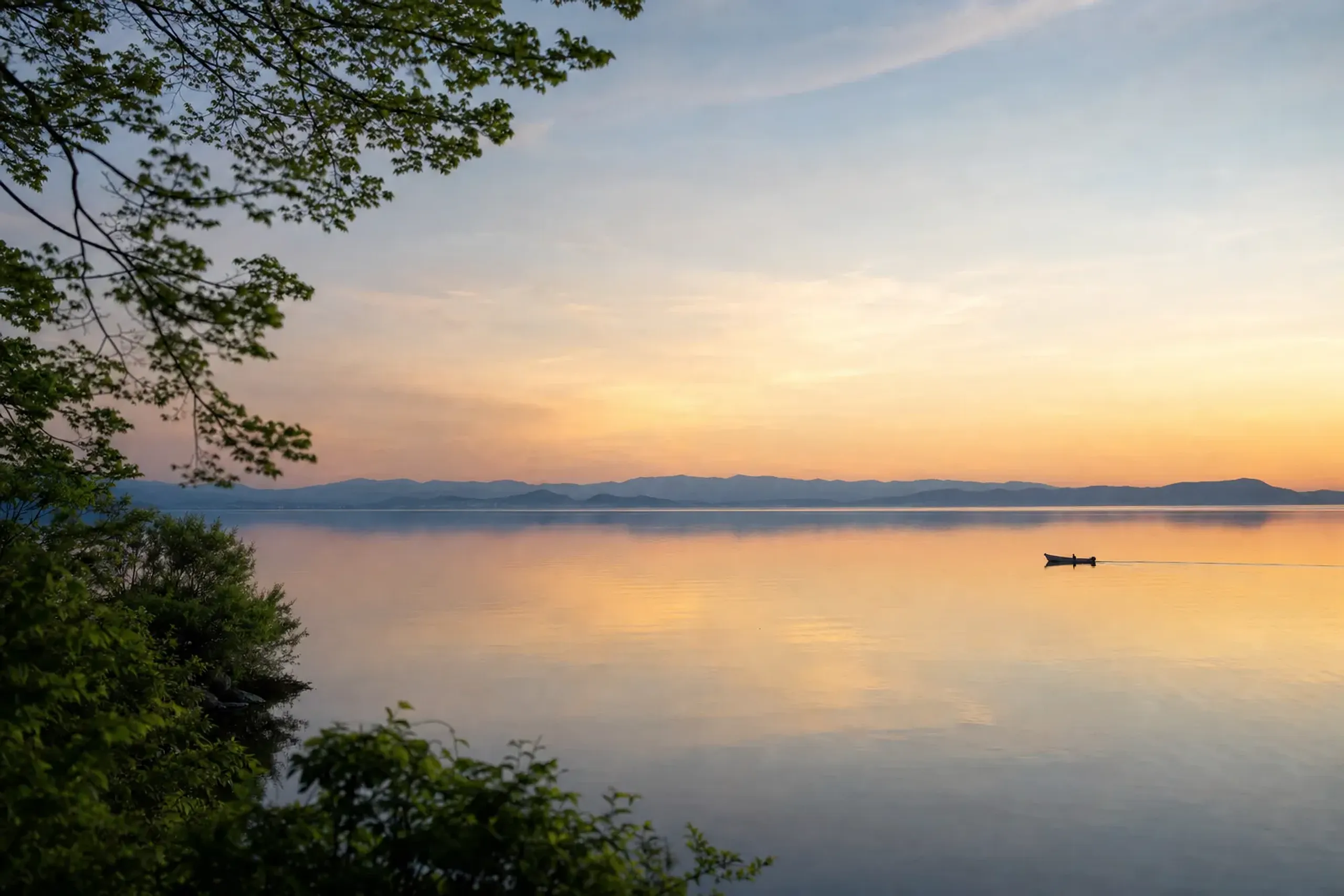 Expansive golden-hour view across Lake Biwa in Shiga with distant hills and open sky