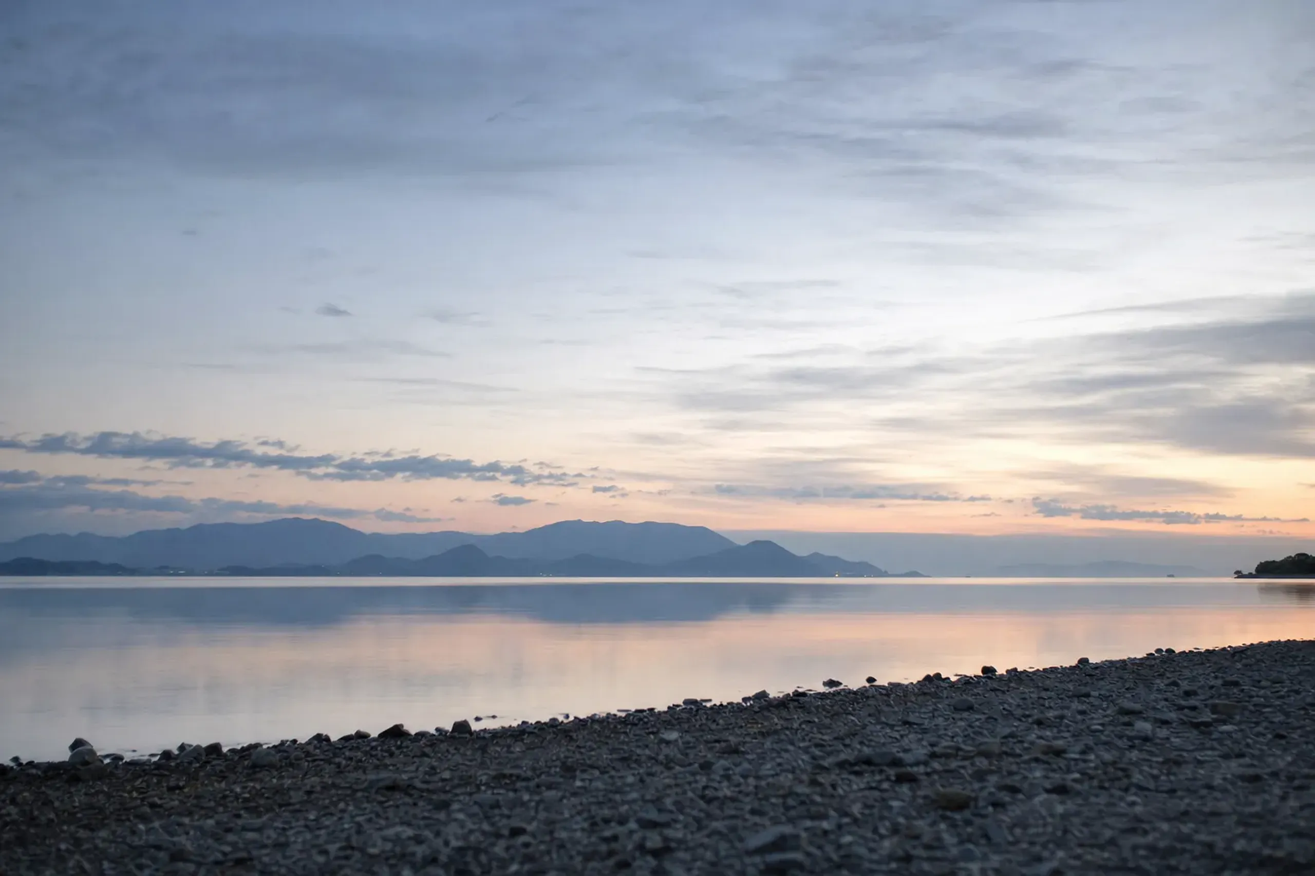 the wide open expanse of Lake Biwa in Shiga, distant hills across still water beneath a broad sky