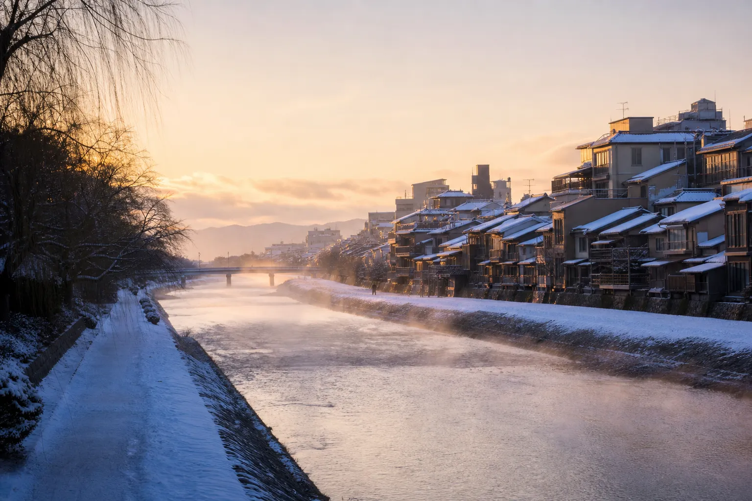 Kamo River in Kyoto at dawn with mist above the water