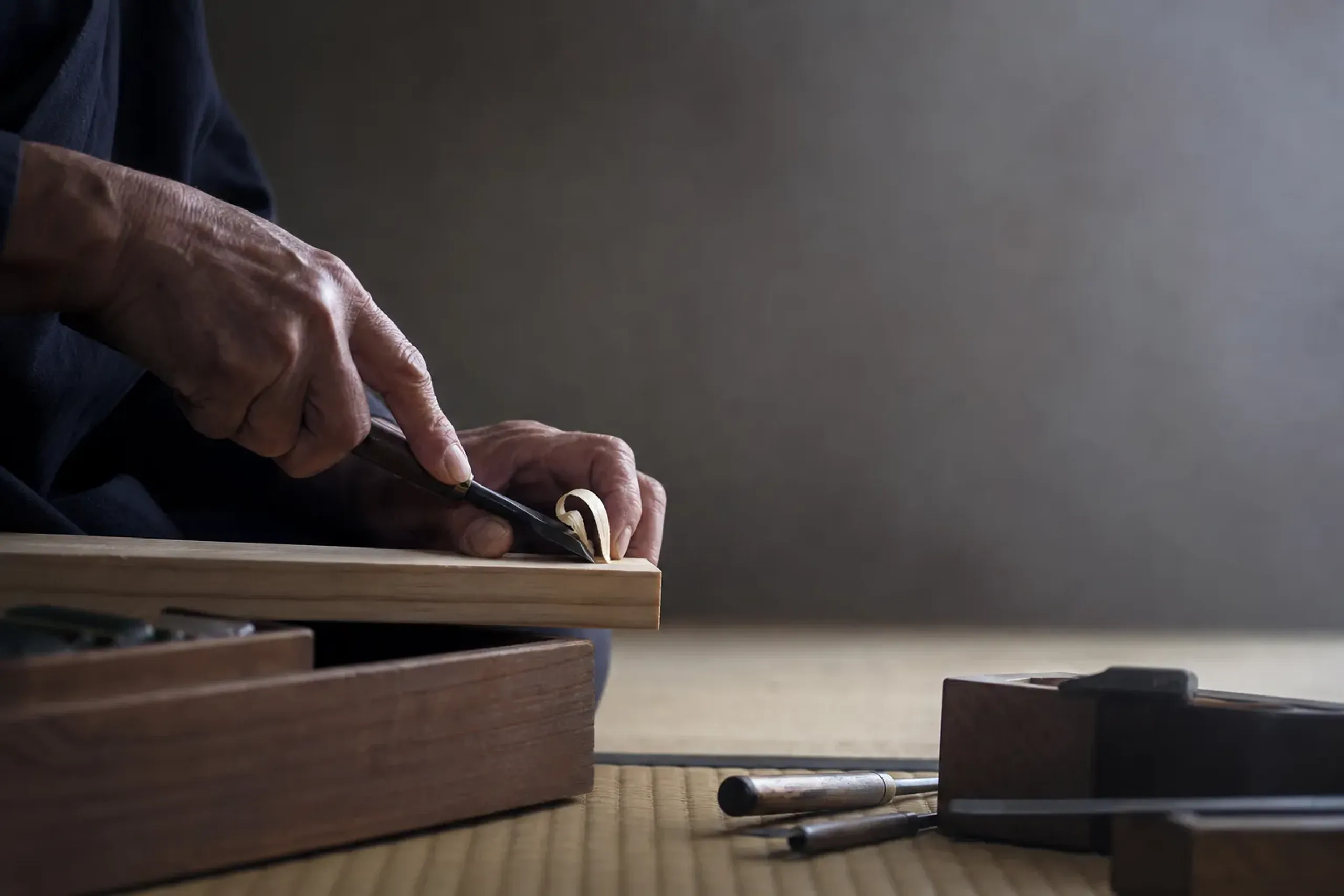 Artisan hands working with traditional tools in Kyoto workshop