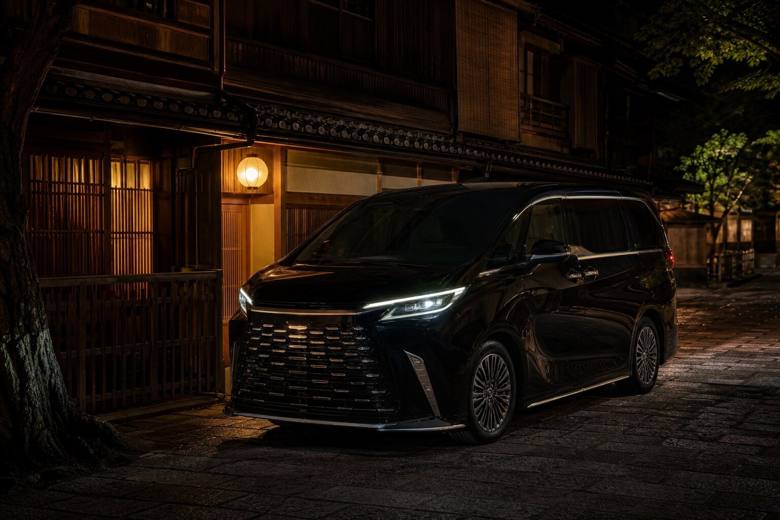Black Lexus LM luxury vehicle parked on a traditional Kyoto street at night