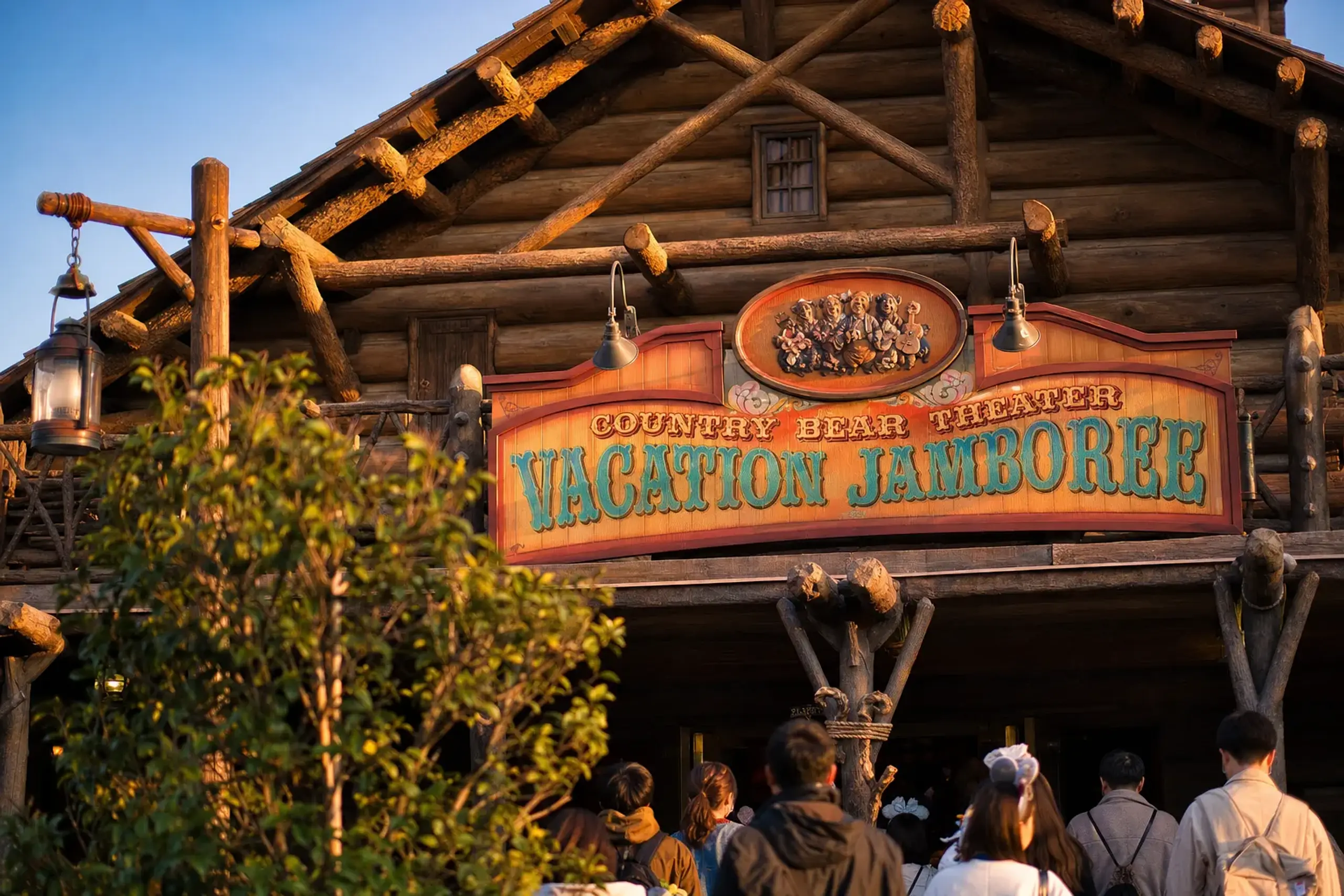 the exterior facade of the Country Bear Theater in Westernland at Tokyo Disneyland, with its rustic wooden log-cabin architecture and Western frontier styling