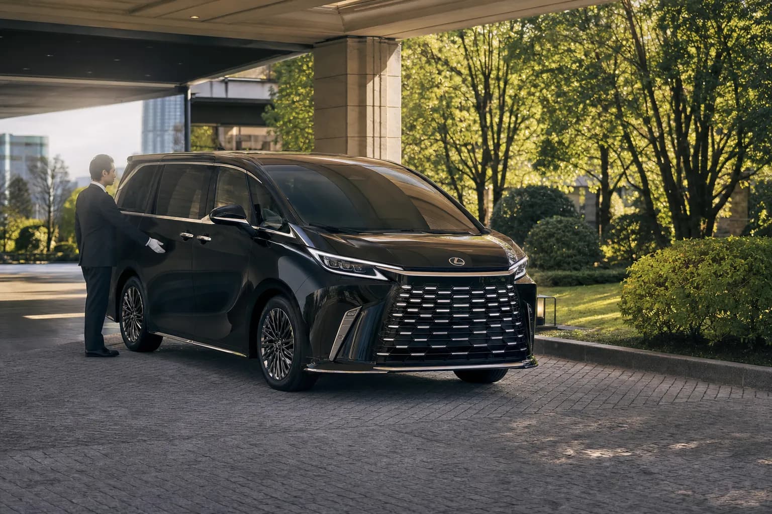 Black luxury minivan with chauffeur at a Tokyo hotel driveway for private transfers