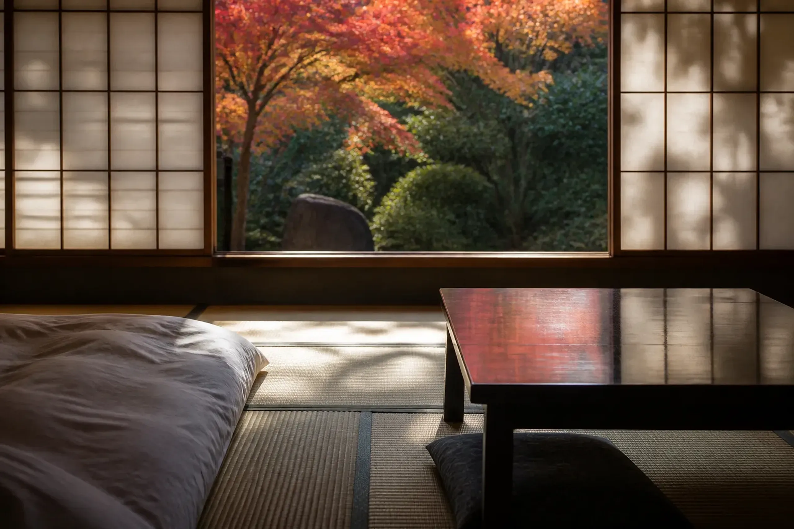 Ryokan-style guest room interior with tatami and shoji-style screens in central Tokyo