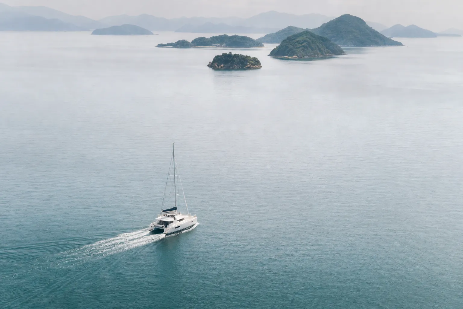Private yacht cruising in the Seto Inland Sea with islands in the background