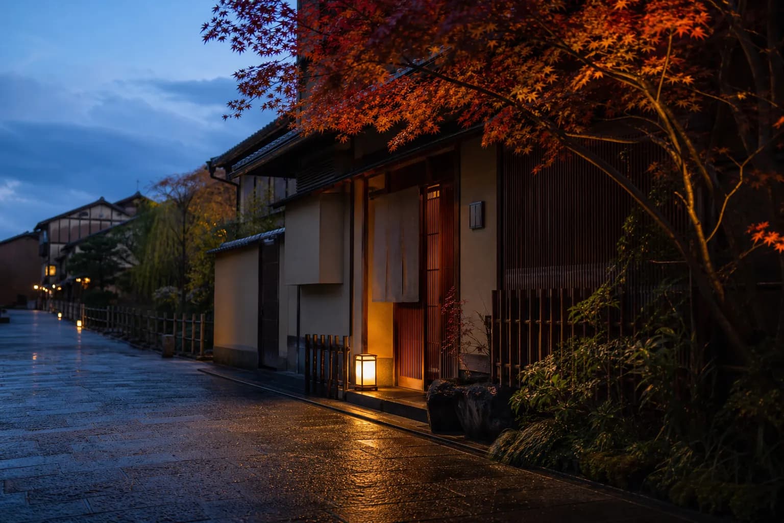 Understated Kyoto luxury hotel entrance on a quiet street at dusk