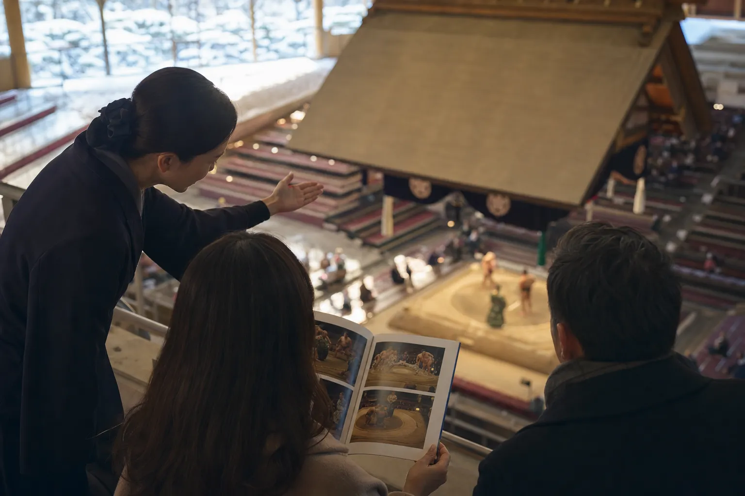 A private tour guide explaining Sumo culture to travelers.