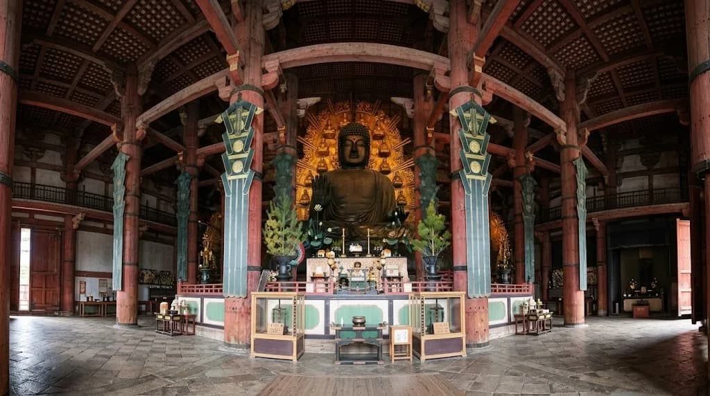 The great bronze Buddha of Todai-ji seated beneath the soaring wooden pillars of its hall in Nara