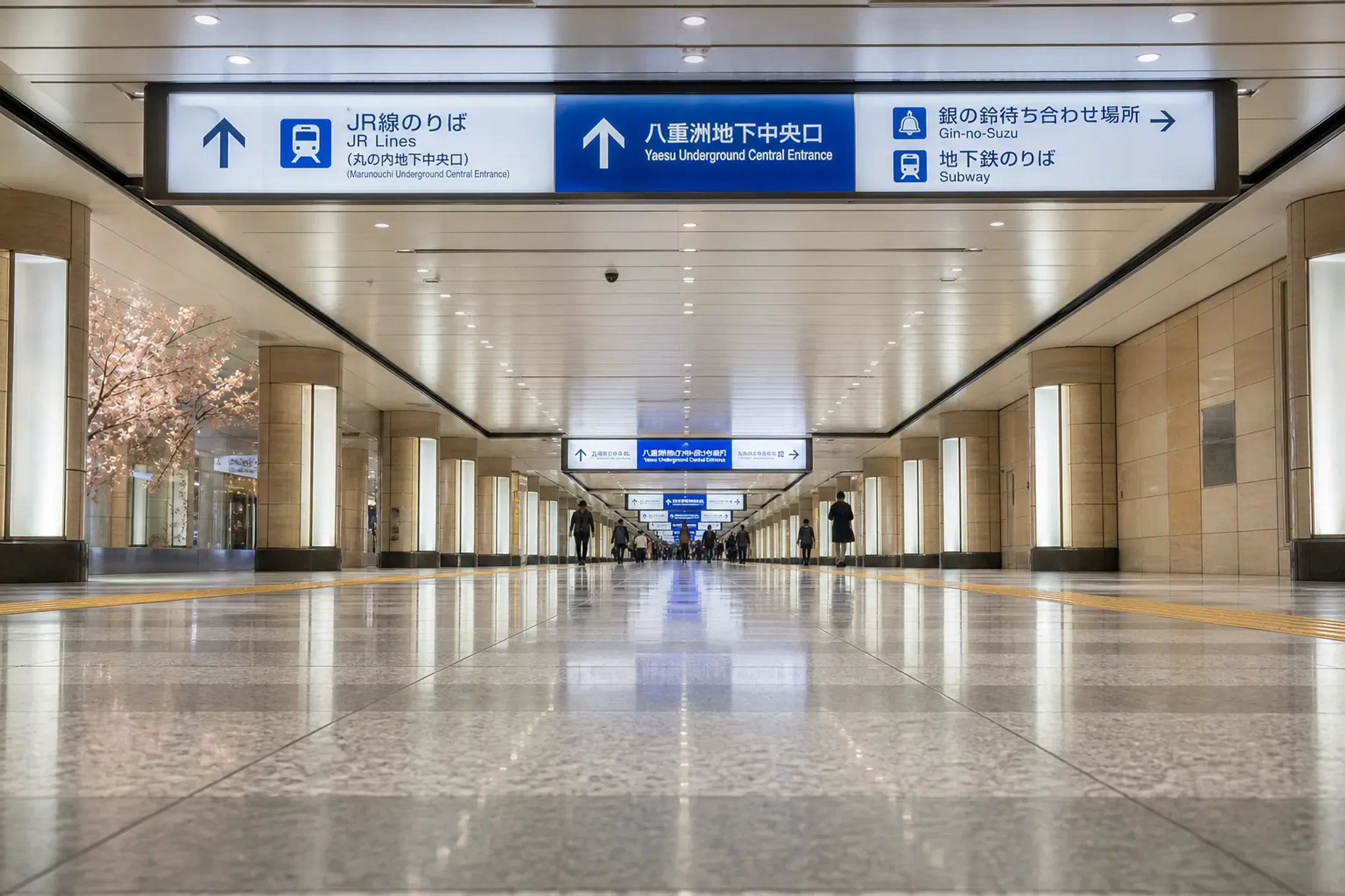 Underground pedestrian passage near Tokyo Station with wayfinding signs