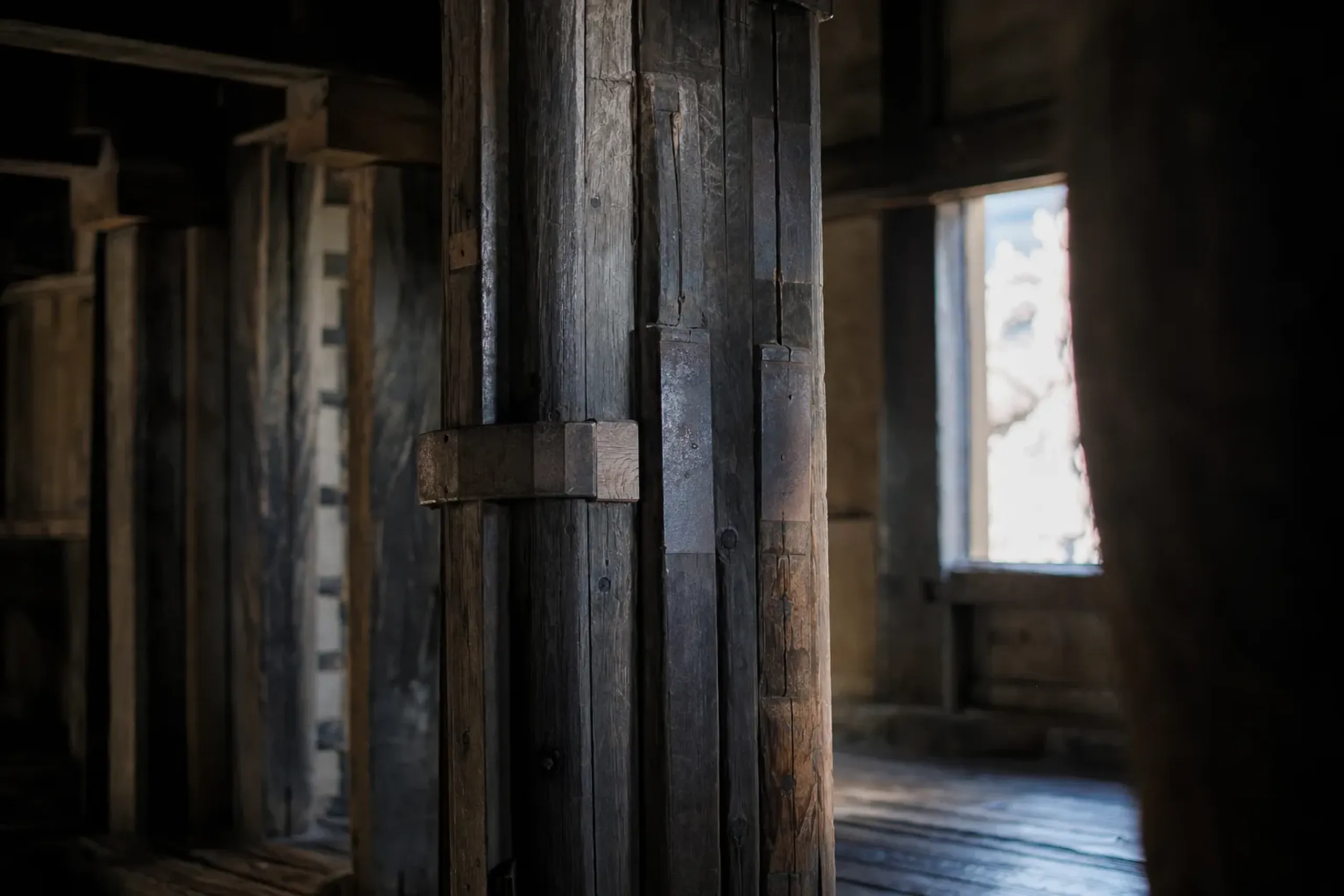 the massive through-pillars and wrapped boards of the Matsue Castle keep's interior timber framing