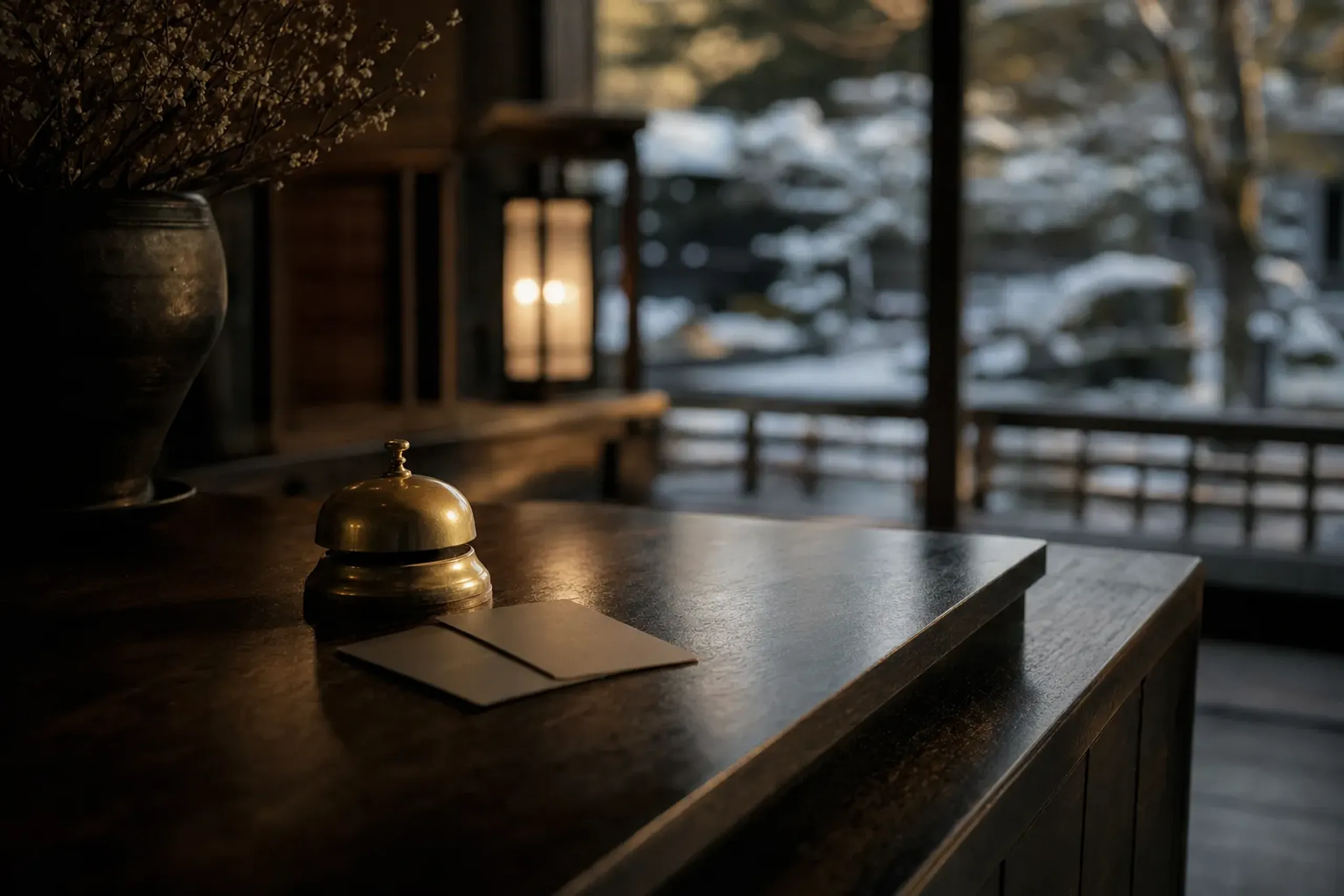 Concierge desk in a Japanese luxury hotel with key cards and warm lighting