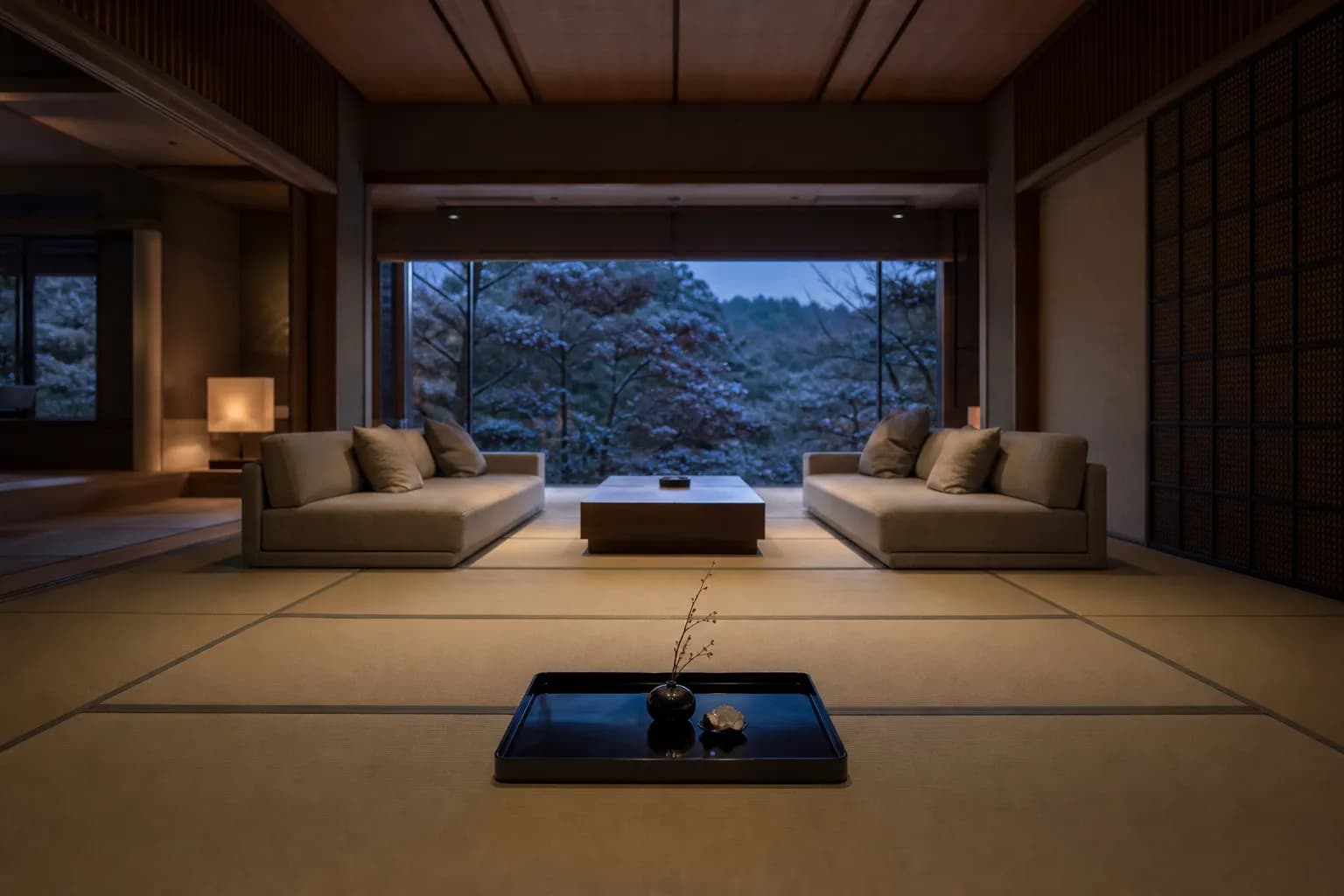 The spacious living room of the Mikado Suite features tatami mats, modern sofas, and large windows.
