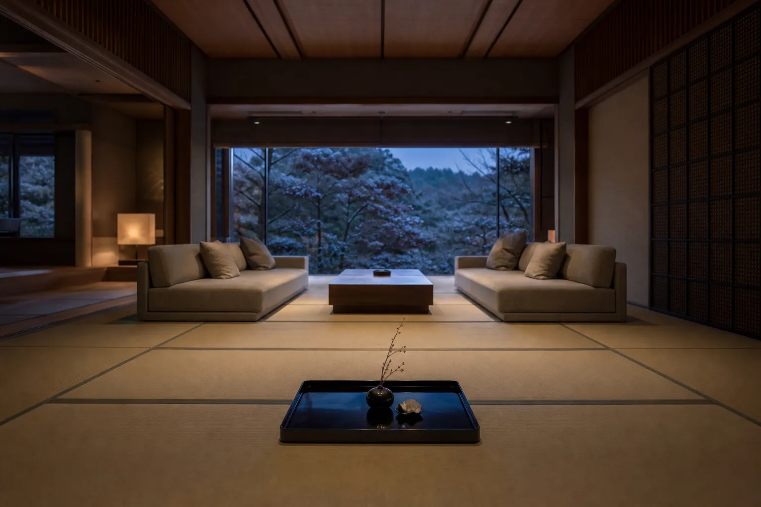 The spacious living room of the Mikado Suite features tatami mats, modern sofas, and large windows.