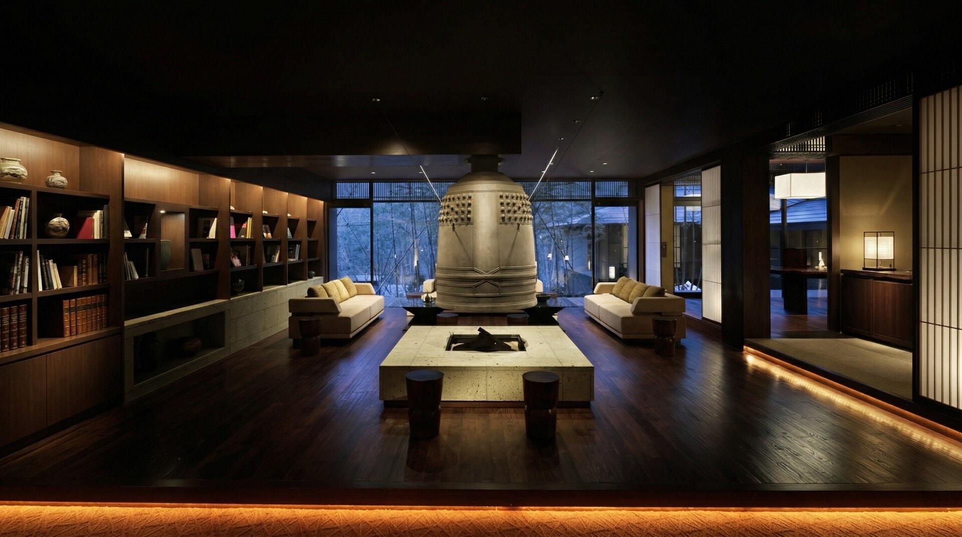 A traditional massive Japanese iron temple bell hanging over a modern fireplace in the Chikusenso lobby.