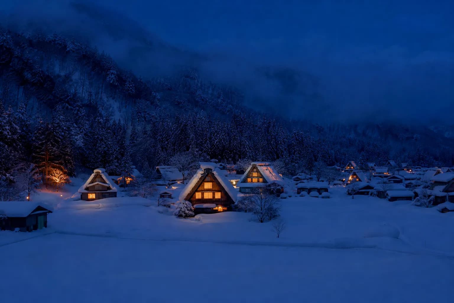 A cinematic evening view of Shirakawa-go village with gassho-zukuri farmhouses covered in deep snow, their windows glowing with warm light against a dark blue winter sky.