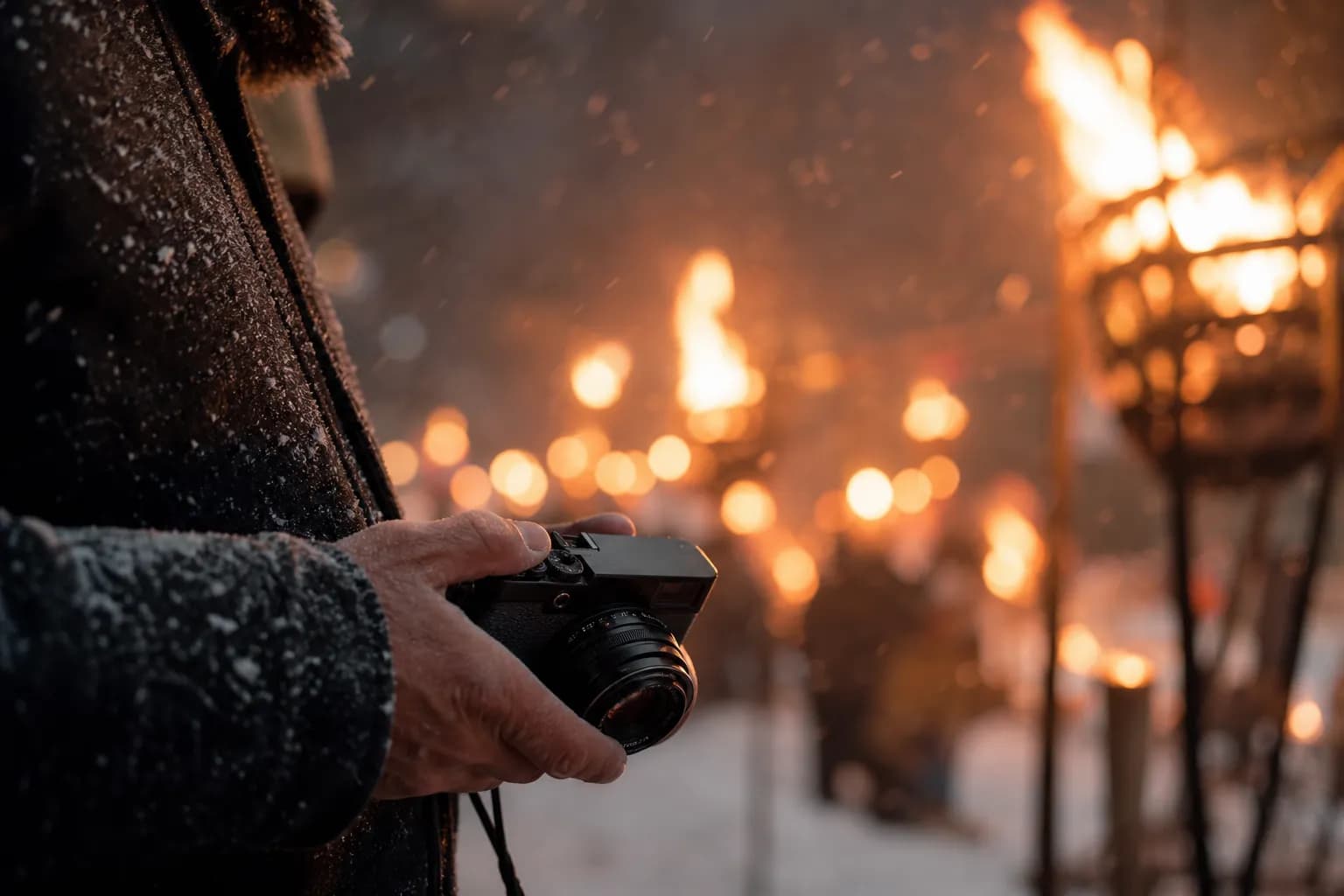 A visitor holding a camera low and discreetly while observing a sacred festival procession in Japan