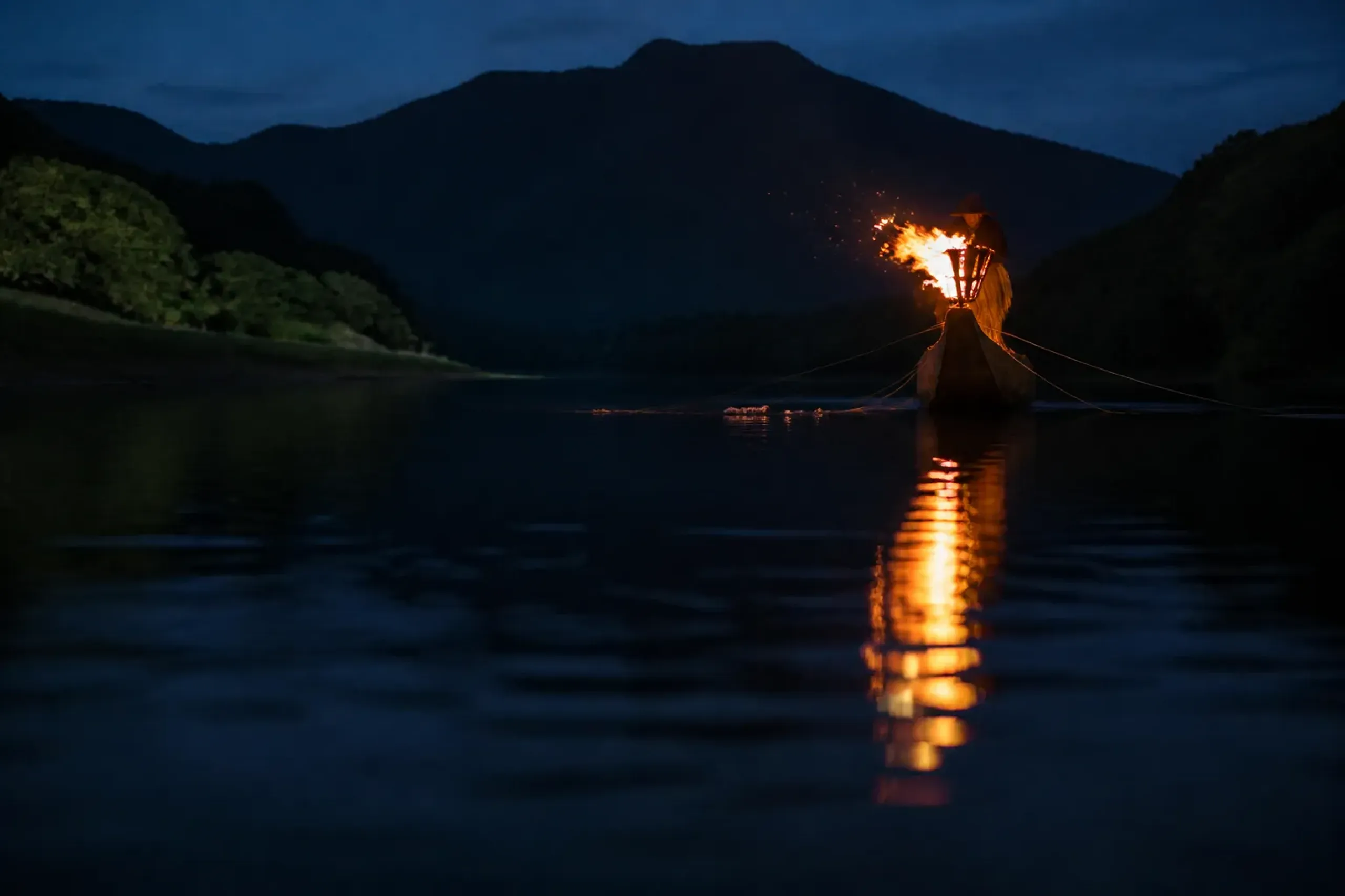 Ukai fishing boat with pine torch on the Nagara River at night in Gifu