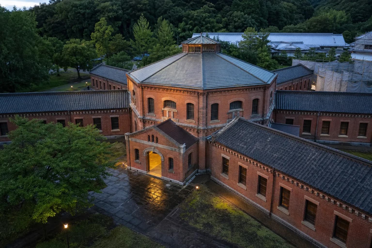 The preserved red-brick Meiji-era facade and cell-block wings of the former Nara Prison, the historic building being converted into HOSHINOYA Nara Prison