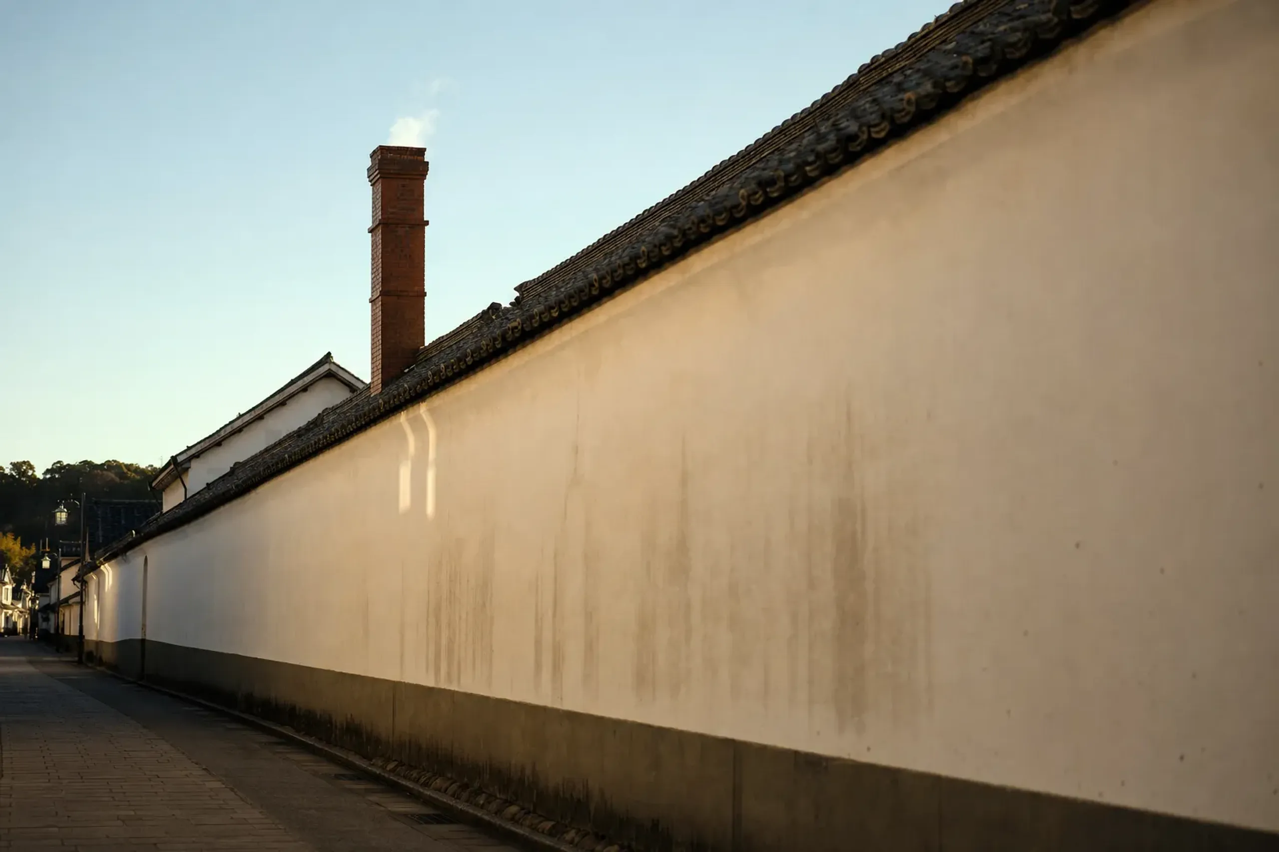 the white plaster walls and red-brick chimneys of a Meiji-era sake brewery along Sakagura-dōri in Saijo, Higashi-Hiroshima