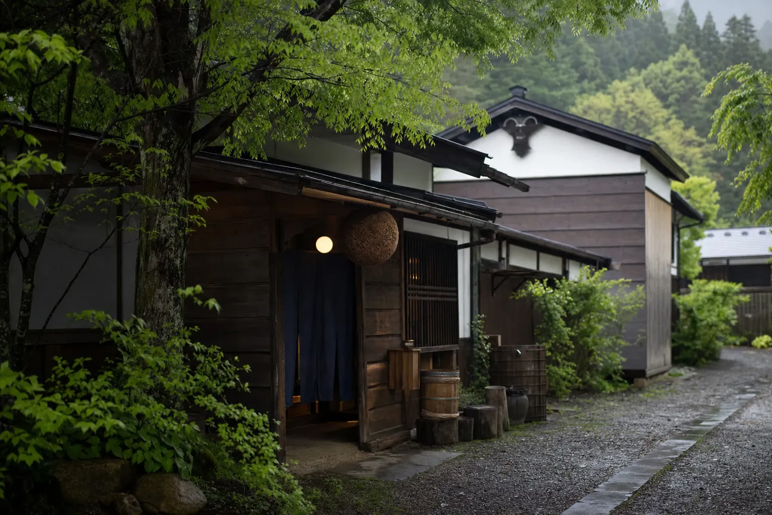 The traditional wooden facade and entrance of Takarayama Sake Brewery in Niigata City under winter light