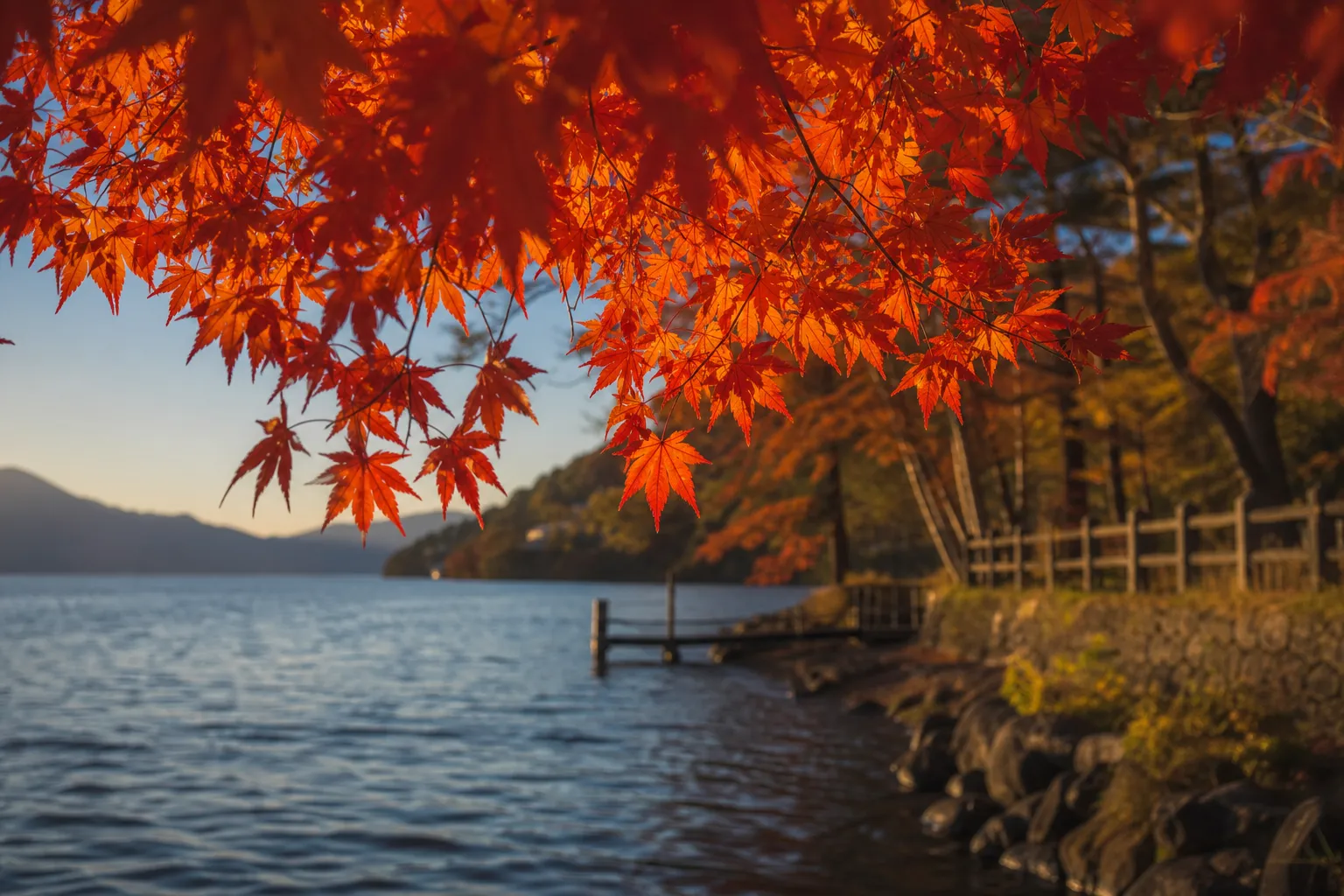 Quiet shoreline view of Lake Chūzenji near Nikko with forested hills