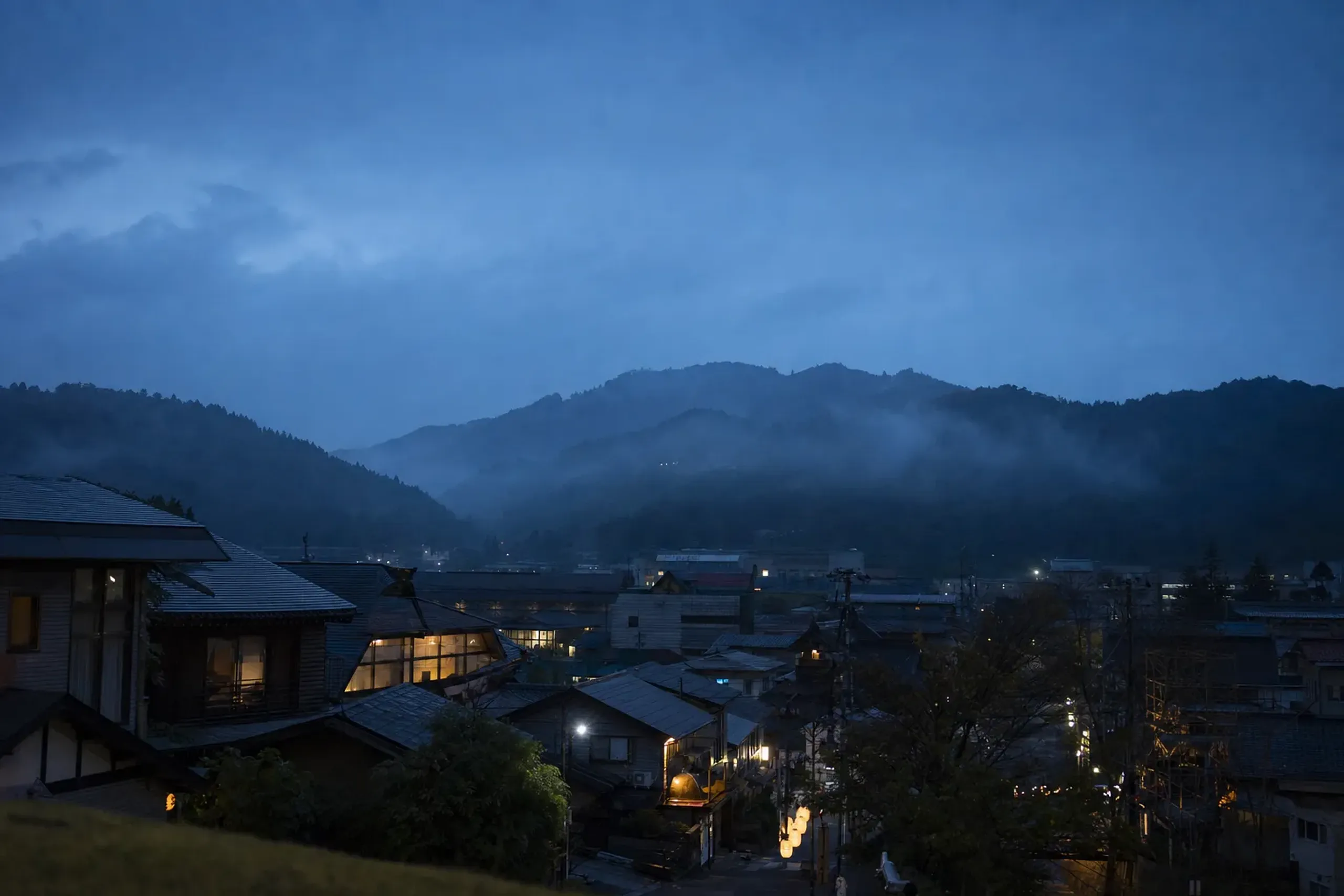 Townscape of Yuzawa in southern Akita, with modest lodging buildings against the surrounding hills