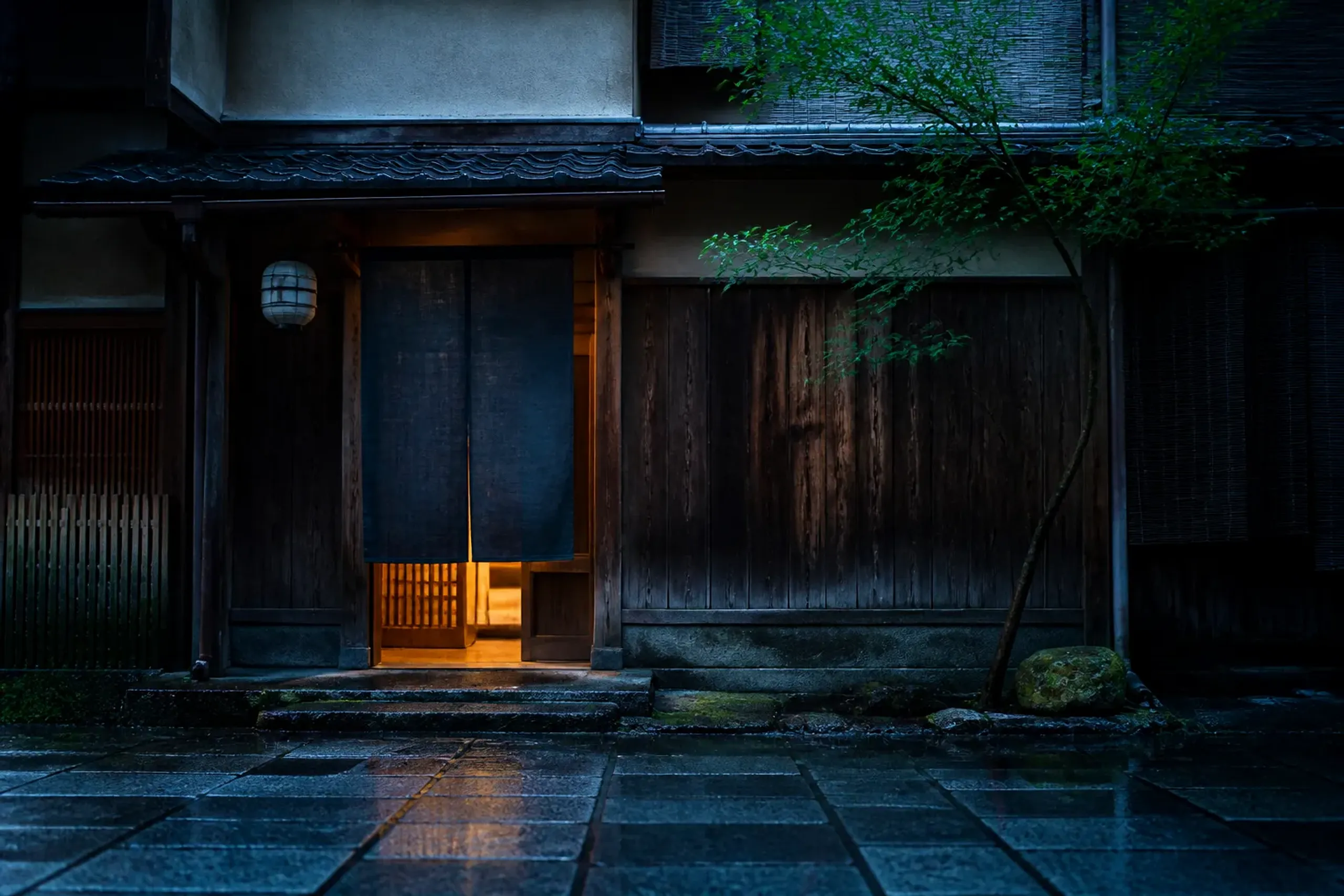 A plain wooden restaurant entrance in Tokyo with a noren curtain and no signage