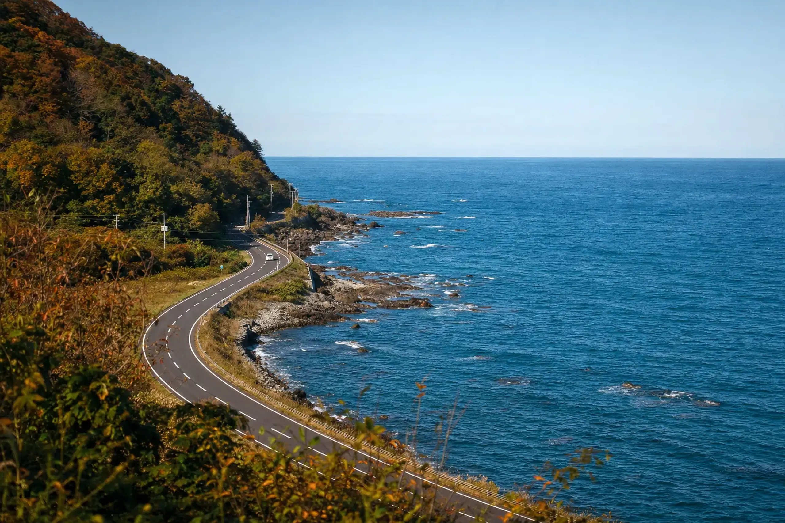 A newly repaired coastal highway on the Noto Peninsula showcasing recovered infrastructure.