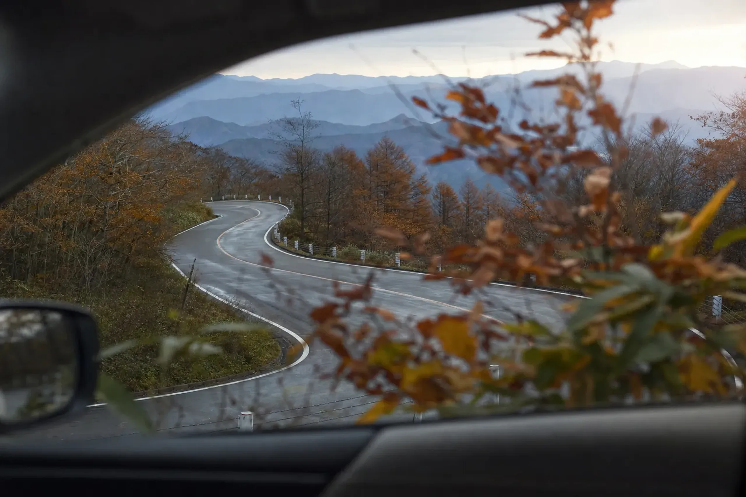 Winding Zaō Echo Line road lined with autumn foliage in October