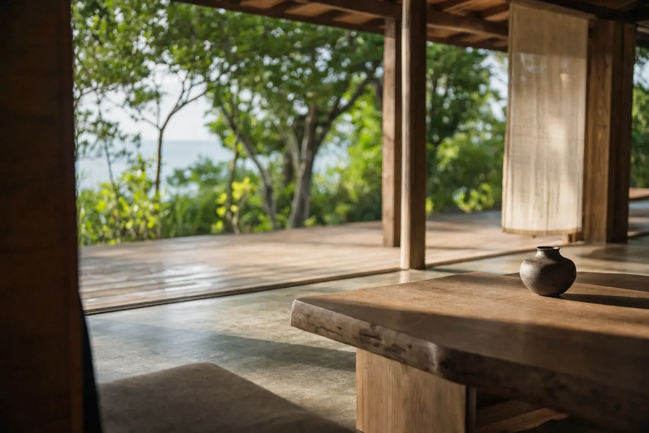 a serene luxury resort lodge interior with natural wood finishes overlooking Okinawan coastal greenery