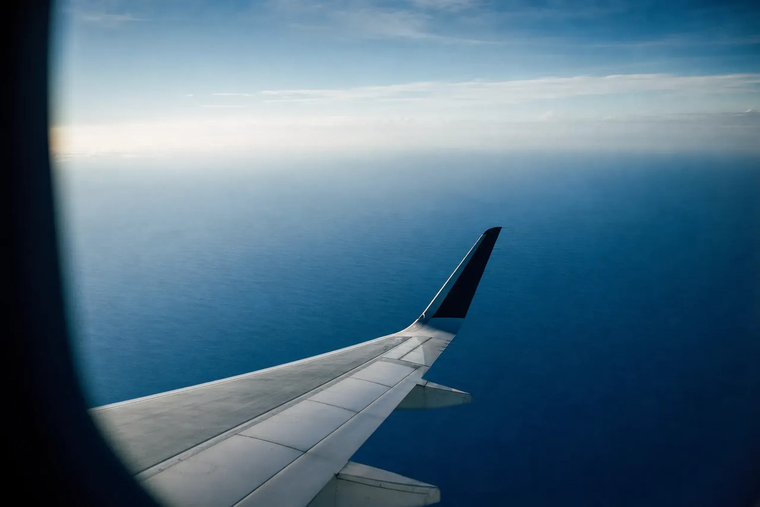 an aircraft wing over the blue Pacific on a flight route connecting the Japanese mainland and Okinawa