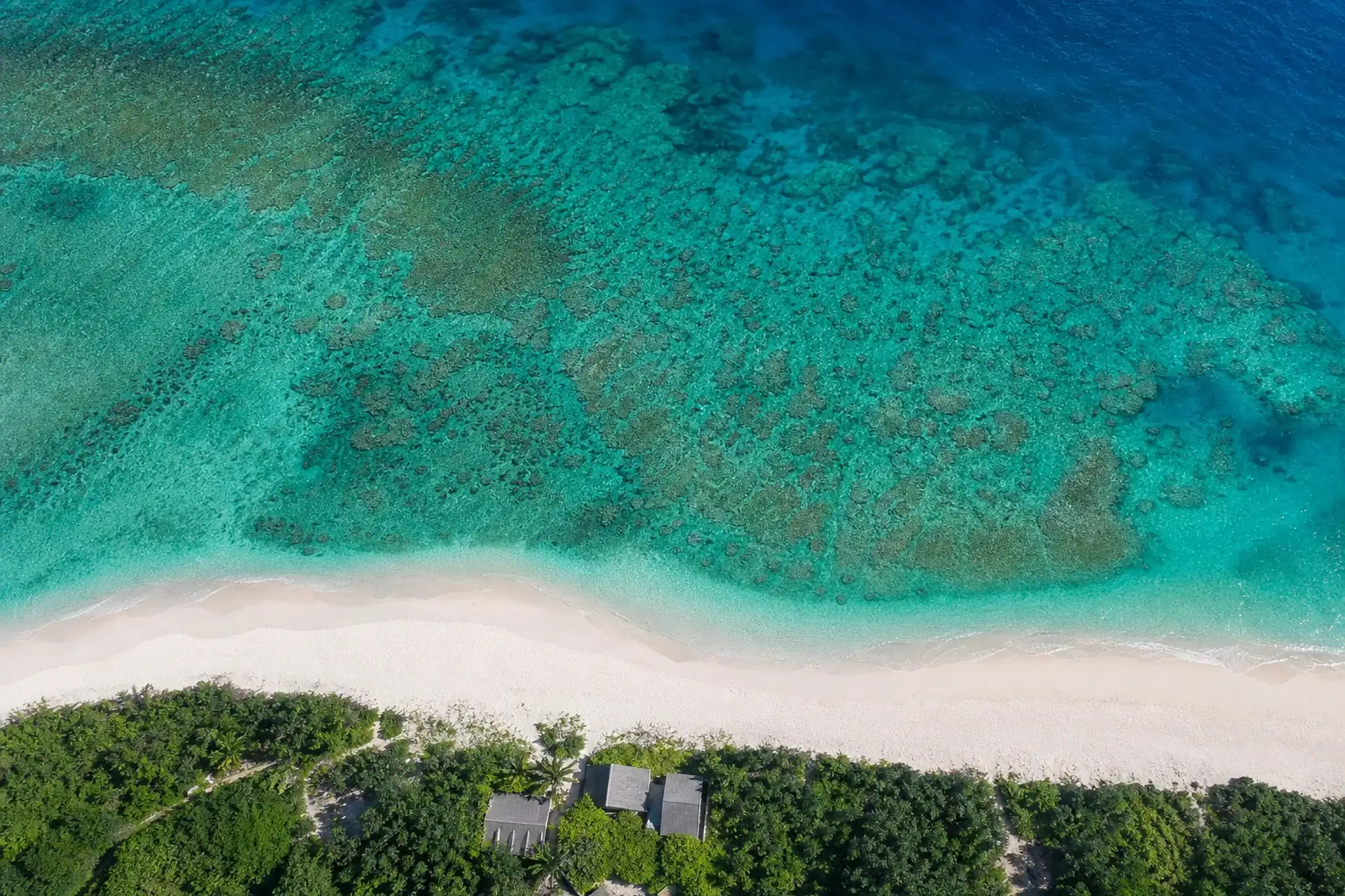 Aerial view of Miyakojima’s turquoise waters and coral reef patterns