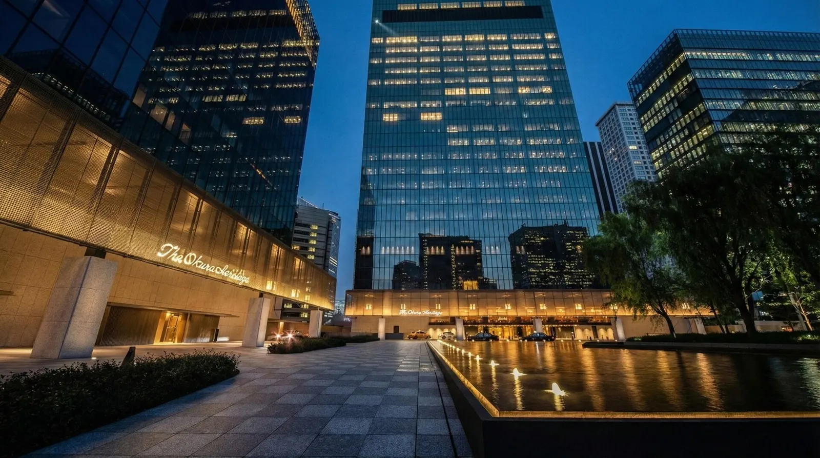 The exterior of The Okura Tokyo Heritage Wing is illuminated gently at night.