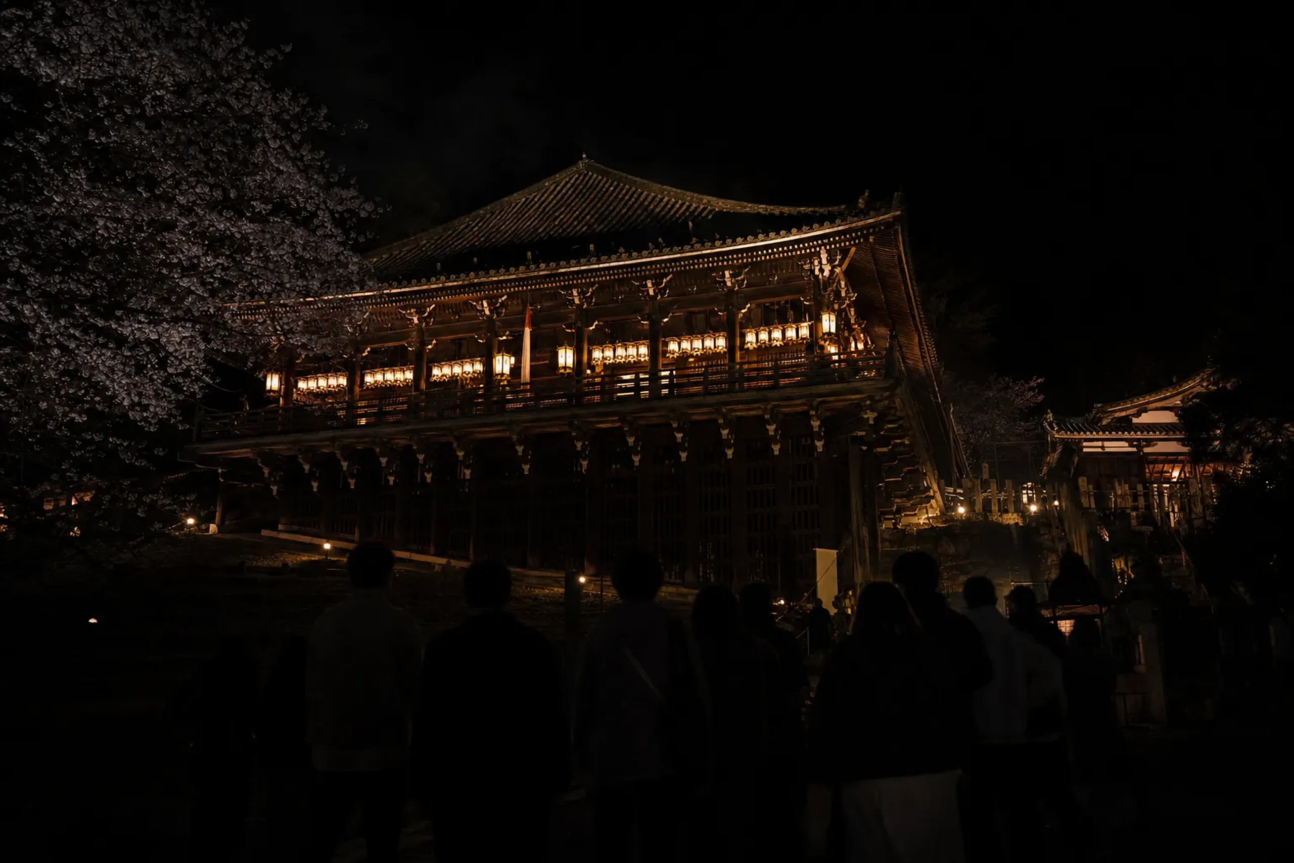 Nigatsudo Hall at Tōdai-ji in Nara at night during Shuni-e, with visitors waiting quietly outdoors