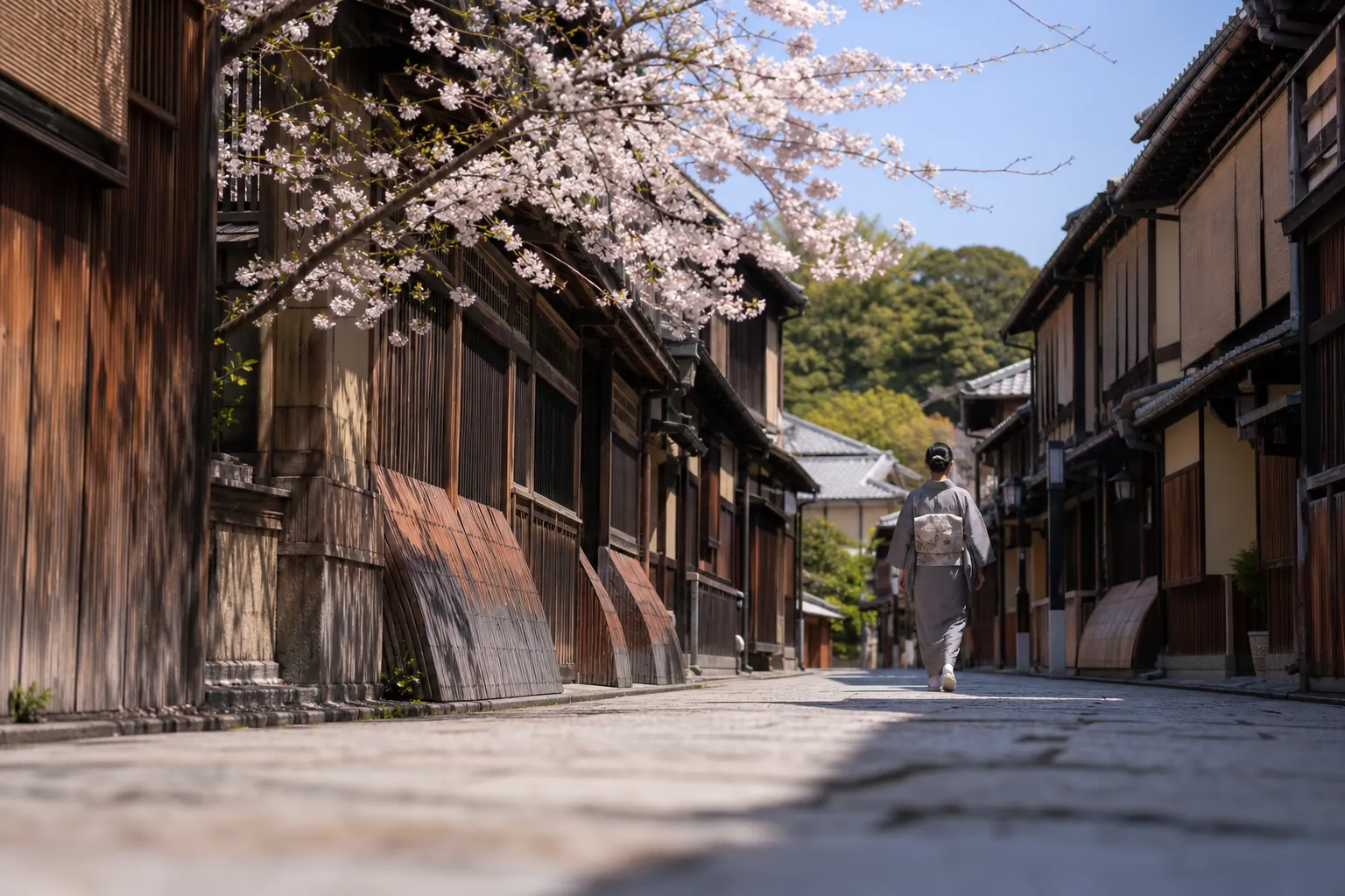 Quiet historic Gion lane in Kyoto with wooden townhouses and cherry blossoms in spring