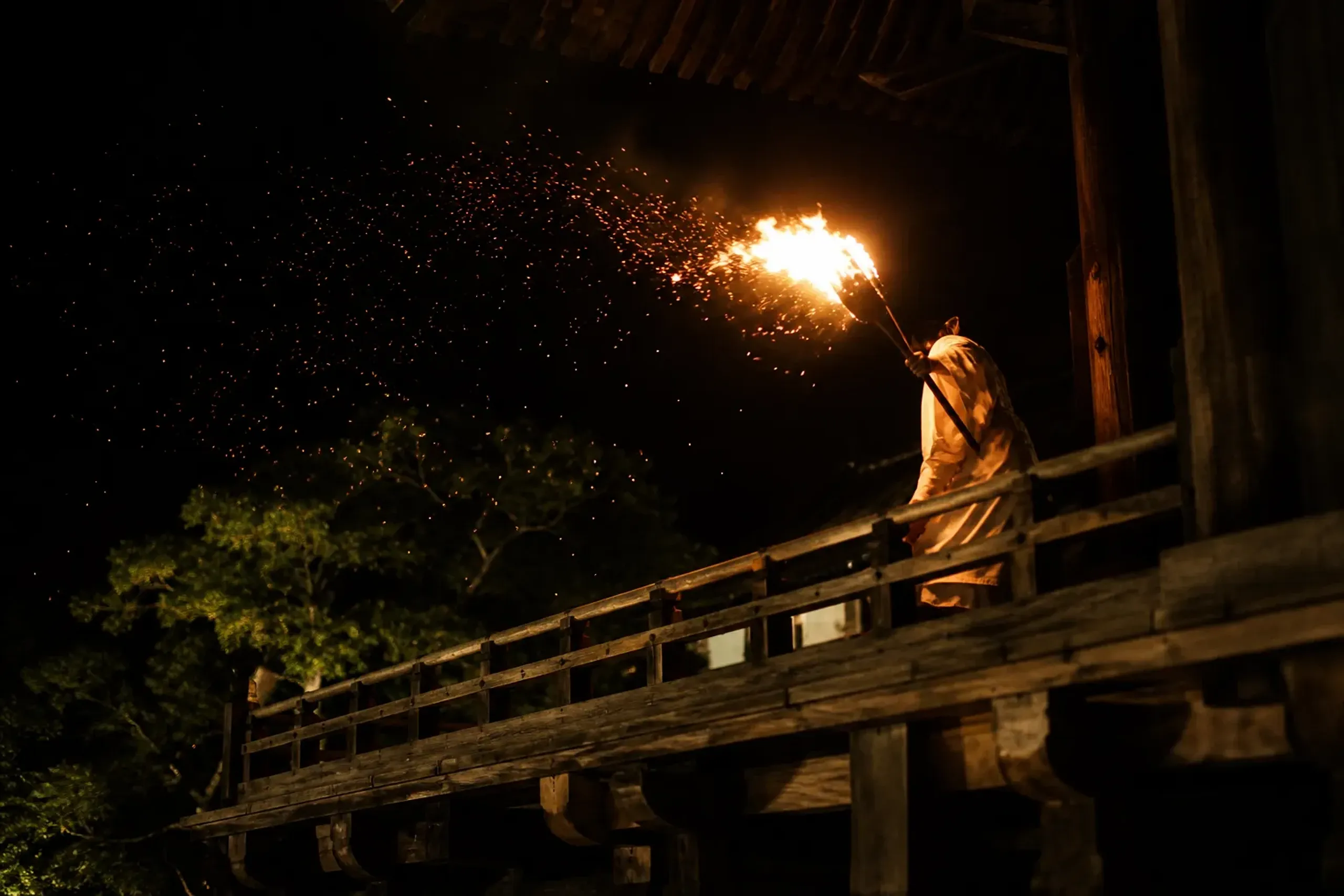 A monk carrying a flaming torch along the balcony of Todai-ji during the Omizutori fire rite in Nara