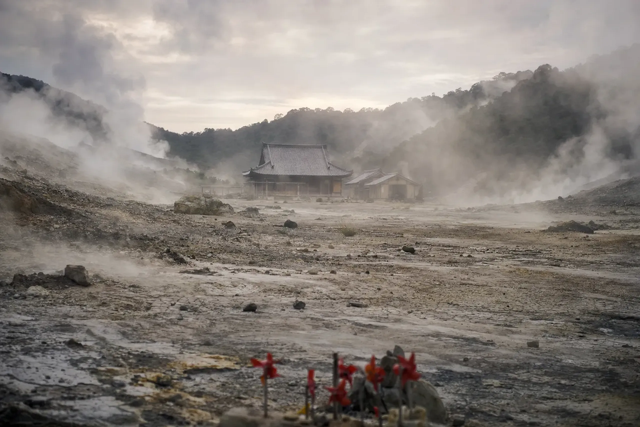 Bodaiji temple at the center of the Osorezan crater, inland from Mutsu City, surrounded by bare cracked volcanic ground and sulfur steam