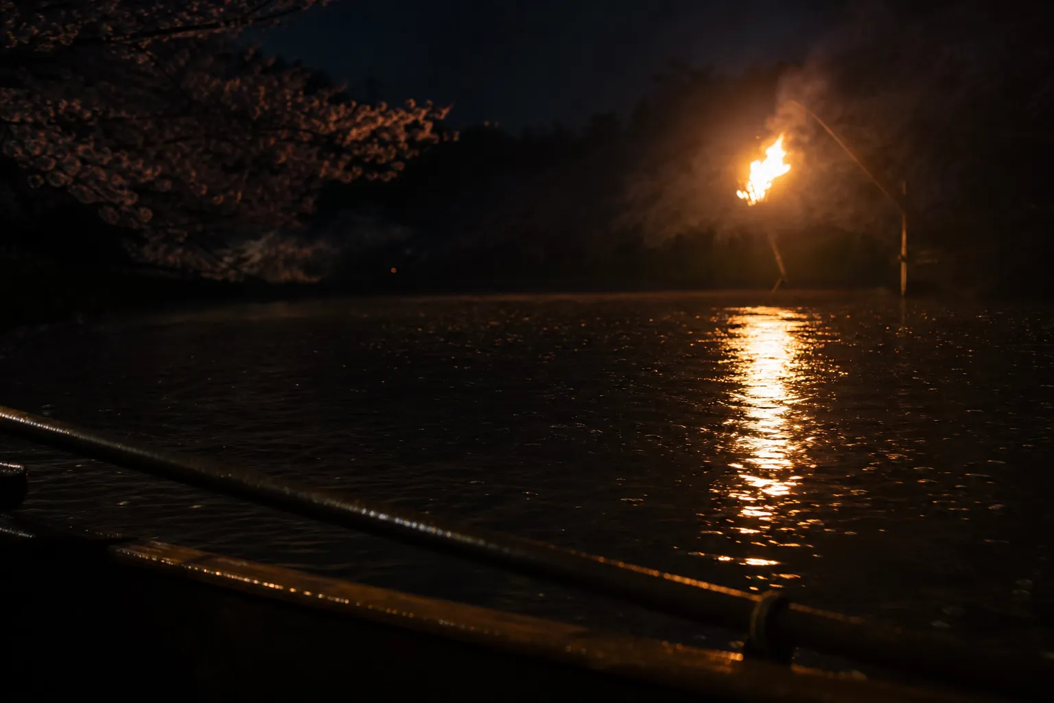 Torchlight reflecting on the Hijikawa River during an Awase Ukai viewing in Ozu