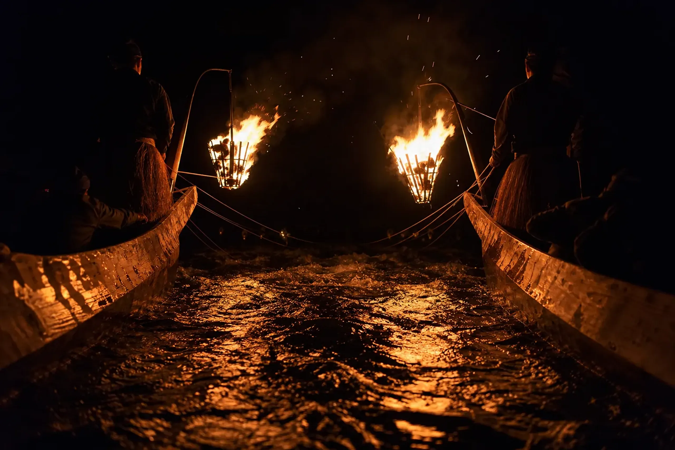 Two boats traveling side-by-side during Awase Ukai on the Hijikawa River in Ozu at night