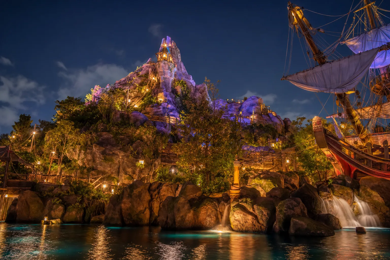 Fantasy Springs area at Tokyo DisneySea at dusk with glowing lanterns and waterfalls