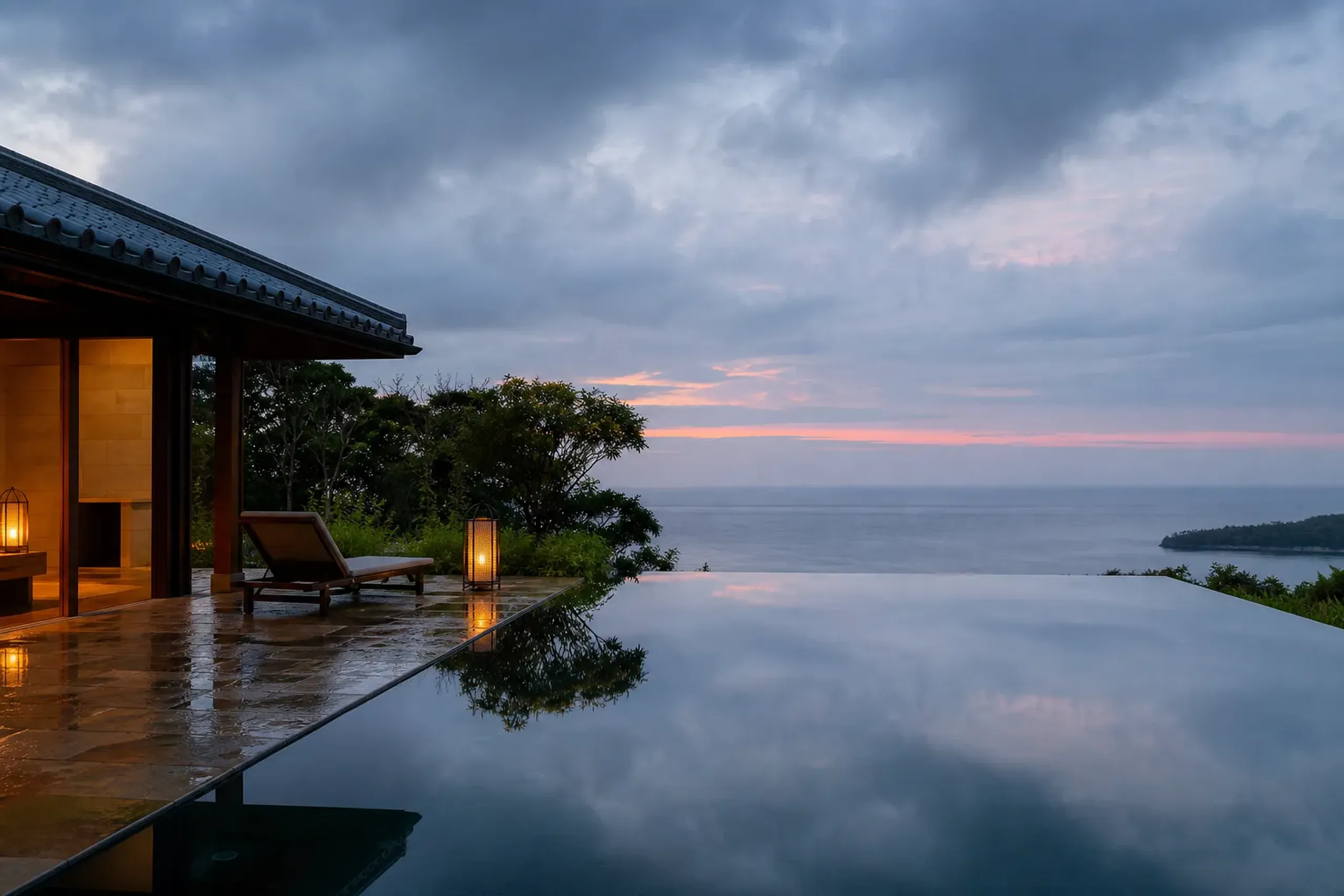 Private villa with infinity pool facing the ocean in Okinawa at dusk