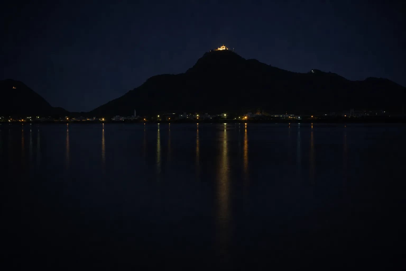 Nagara River at night with illuminated Gifu Castle on Mount Kinka in the background