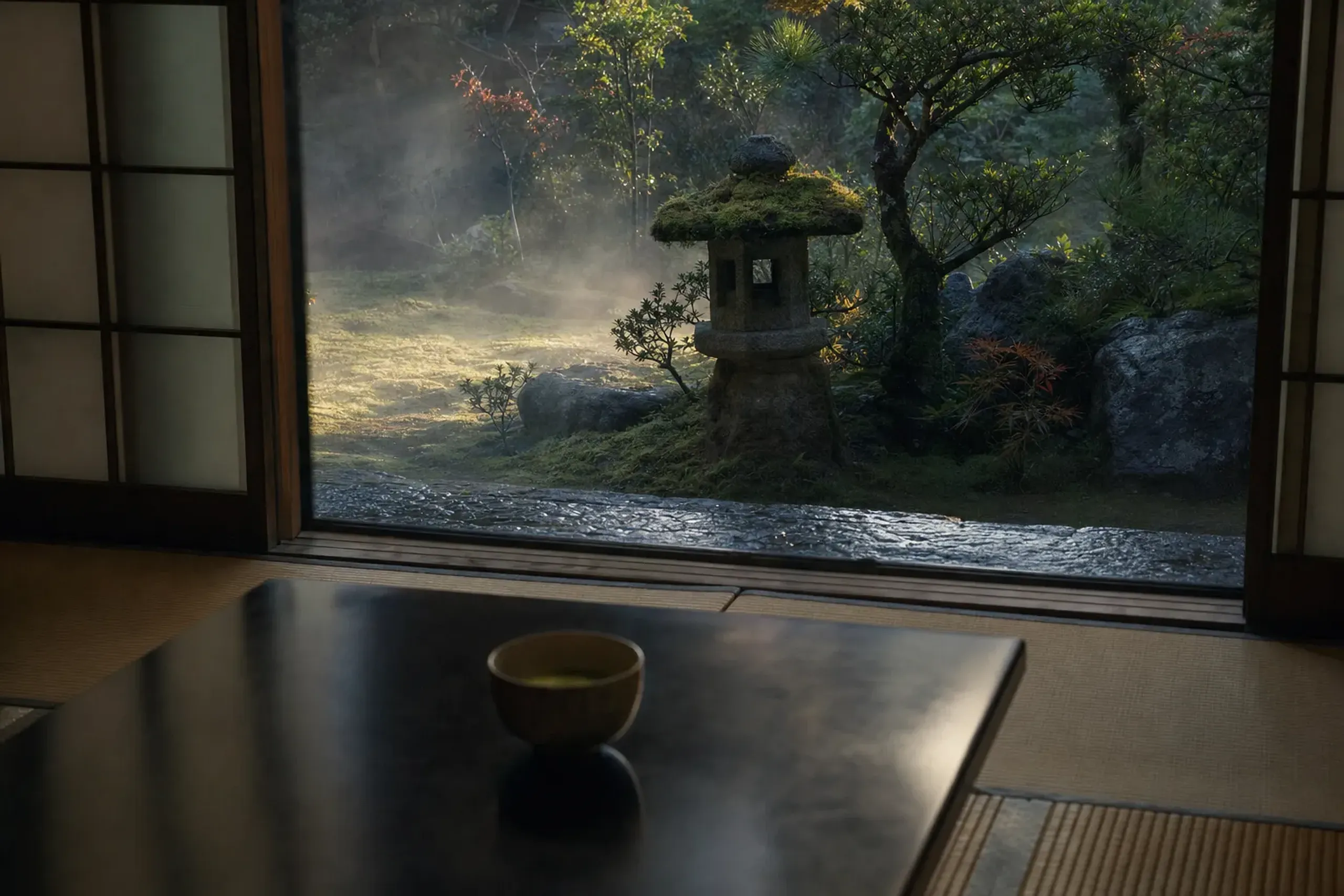 a traditional Izumo ryokan's tatami room with a low lacquered table, viewed toward a quiet inner garden at first light