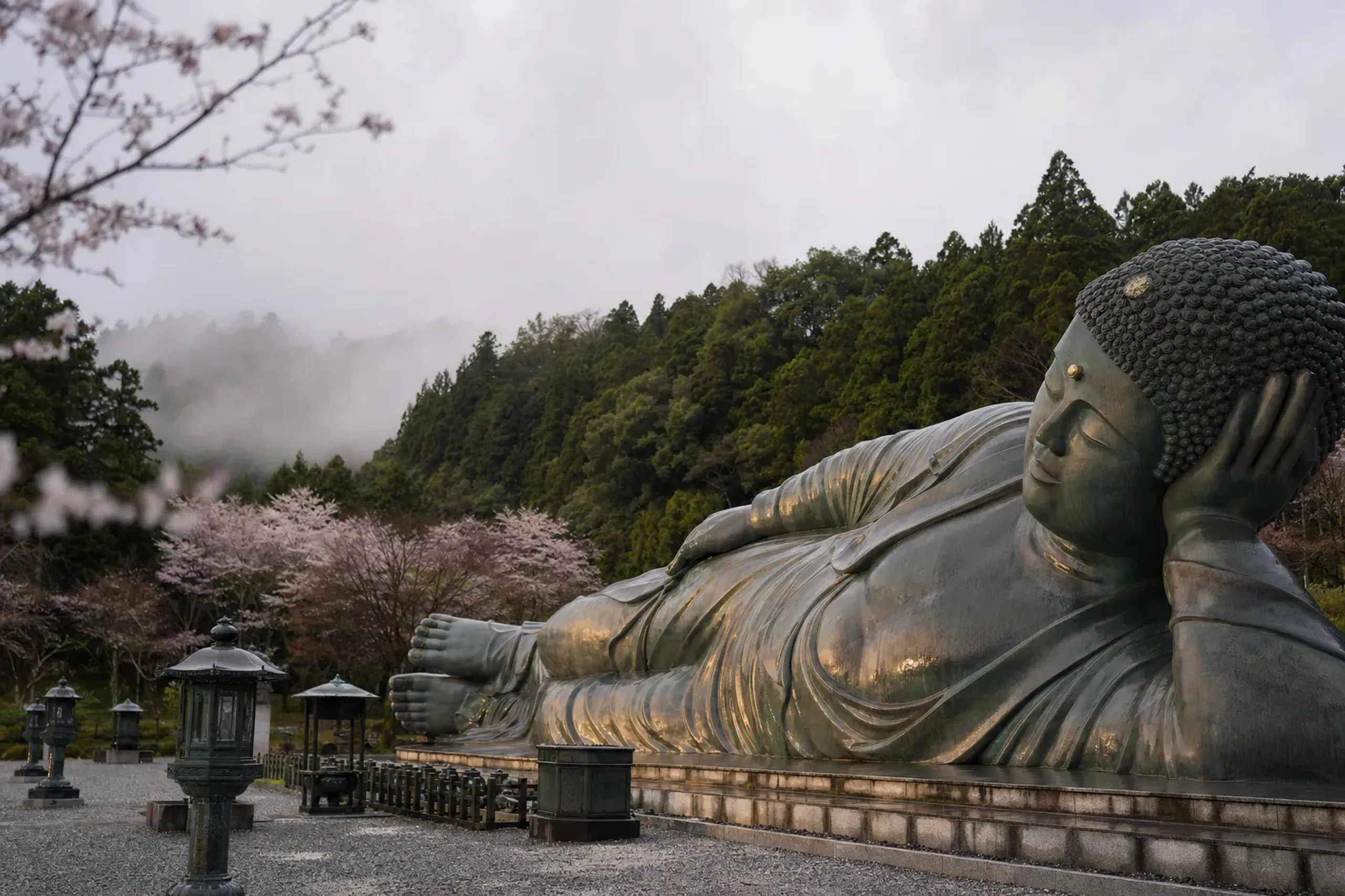 the 41-metre-long bronze reclining Buddha of Nanzō-in glowing in muted daylight, cloud shadows moving across its surface